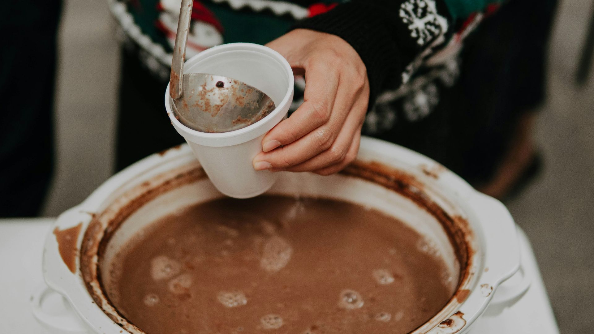 person holding white cup