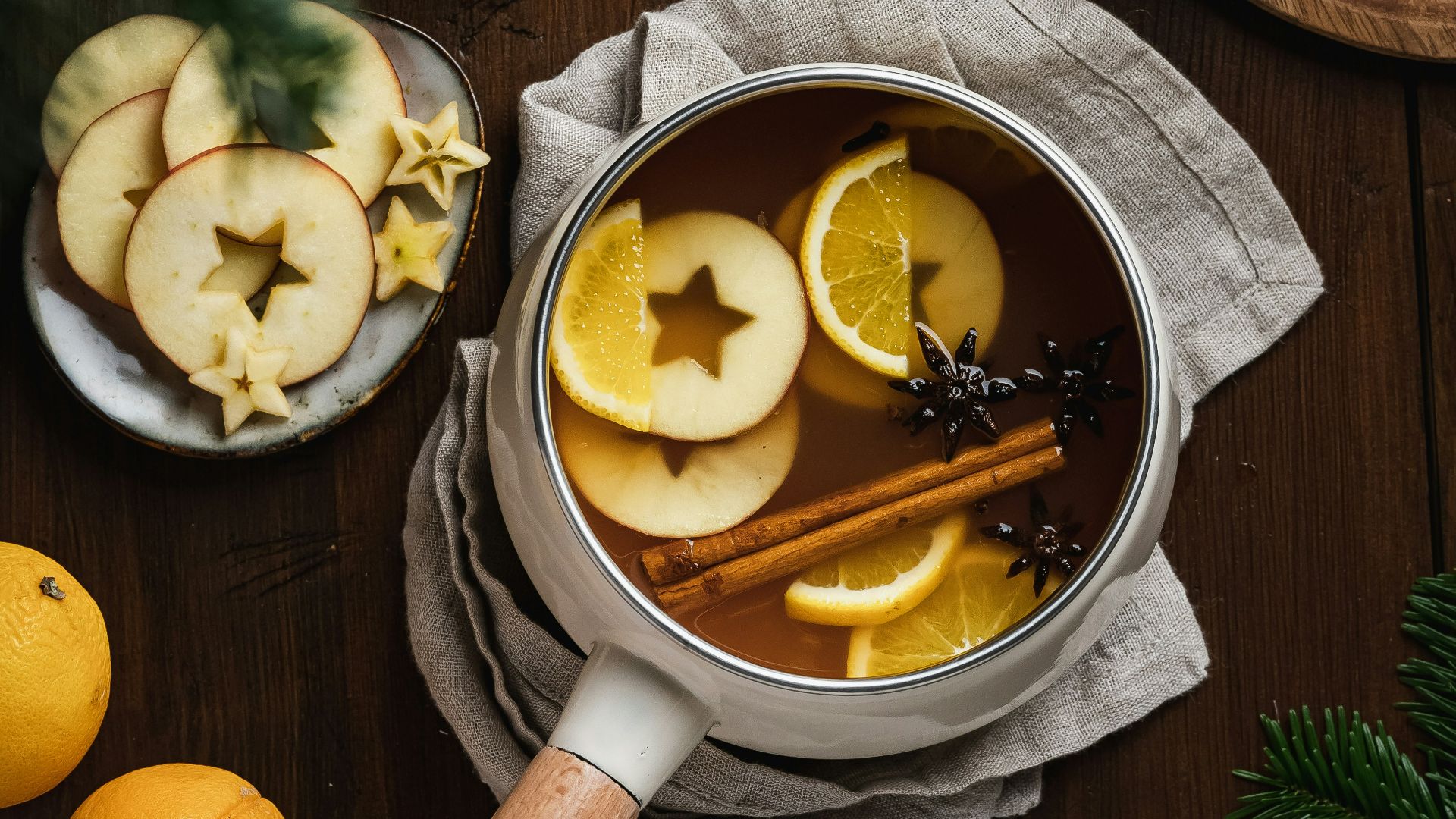 a wooden spoon with lemons and a bowl of sliced lemons