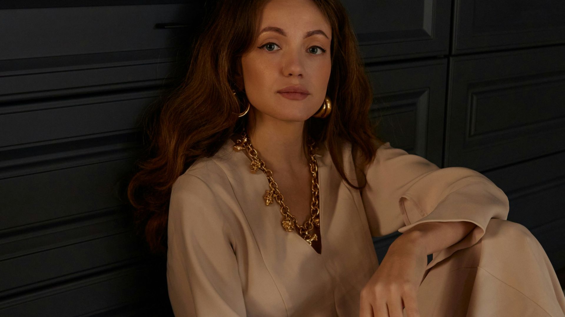 a woman sitting on the floor in a room