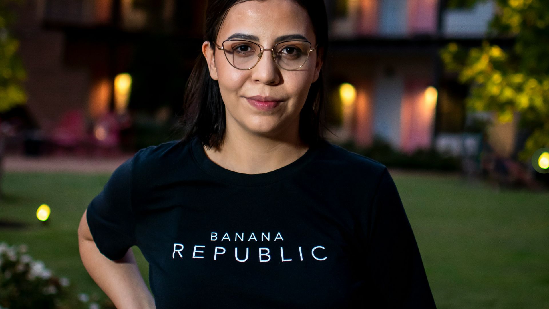 smiling woman in black crew neck t-shirt wearing black framed eyeglasses