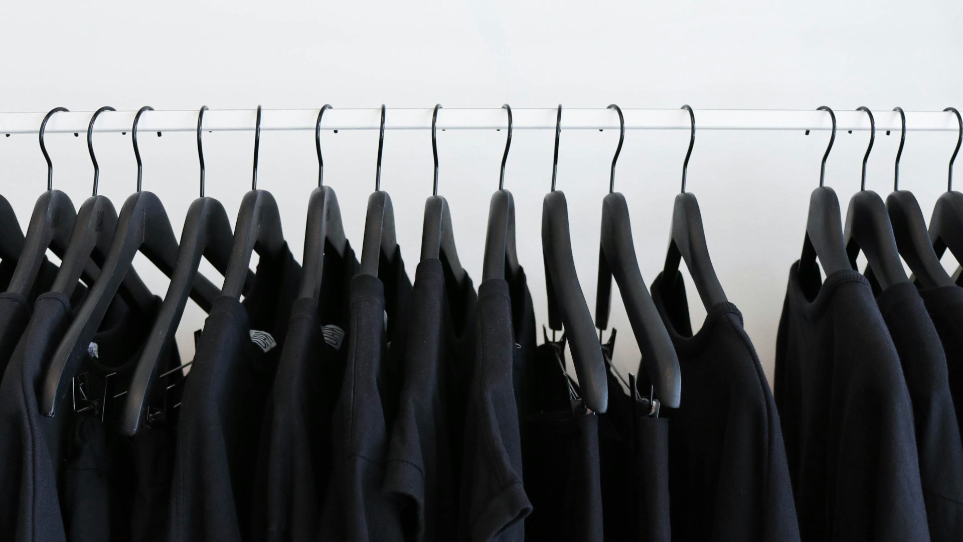 black clothes hanged in rack