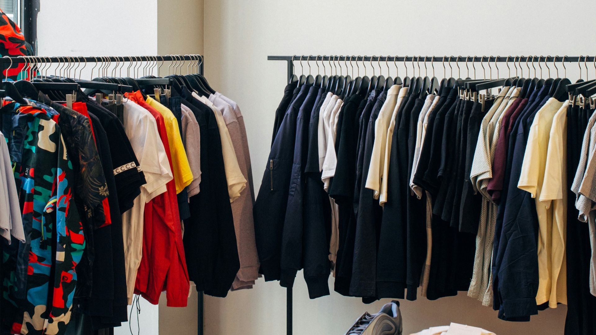assorted-color clothes hanging on metal racks