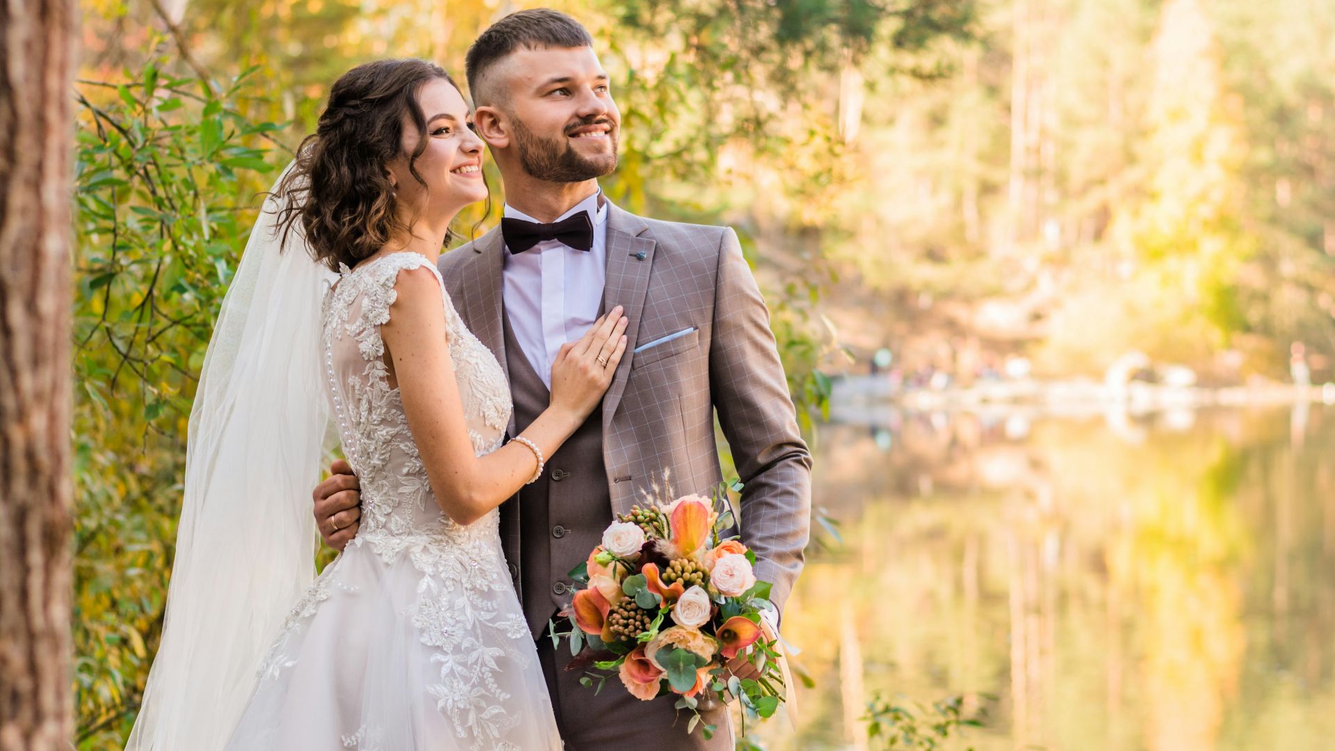 man in gray suit and woman in white wedding dress