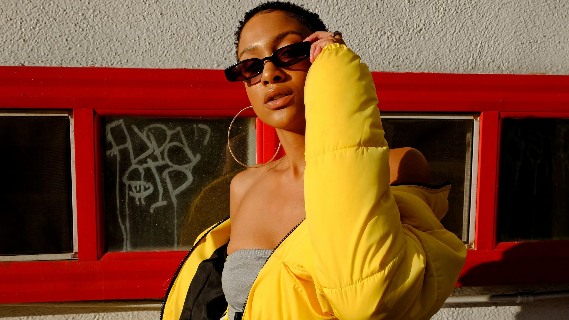 woman holding her sunglasses