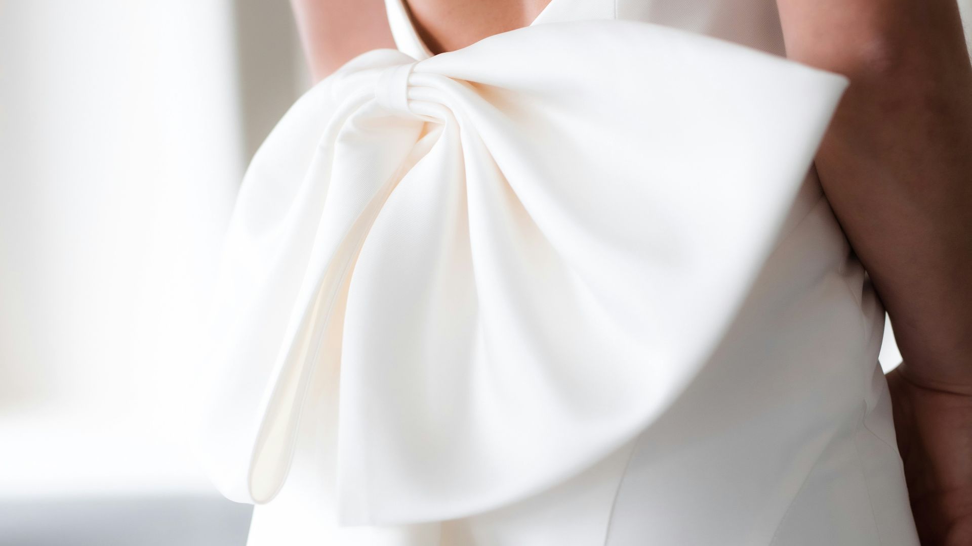the back of a woman's dress with a large bow
