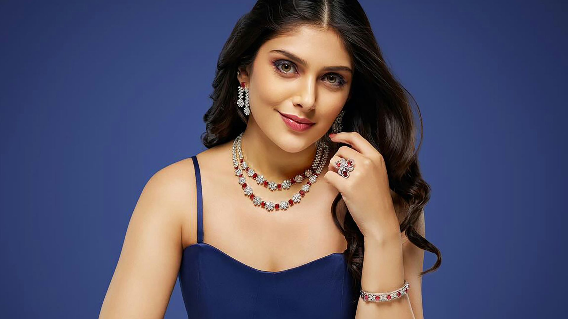 A woman in a blue dress sitting at a table