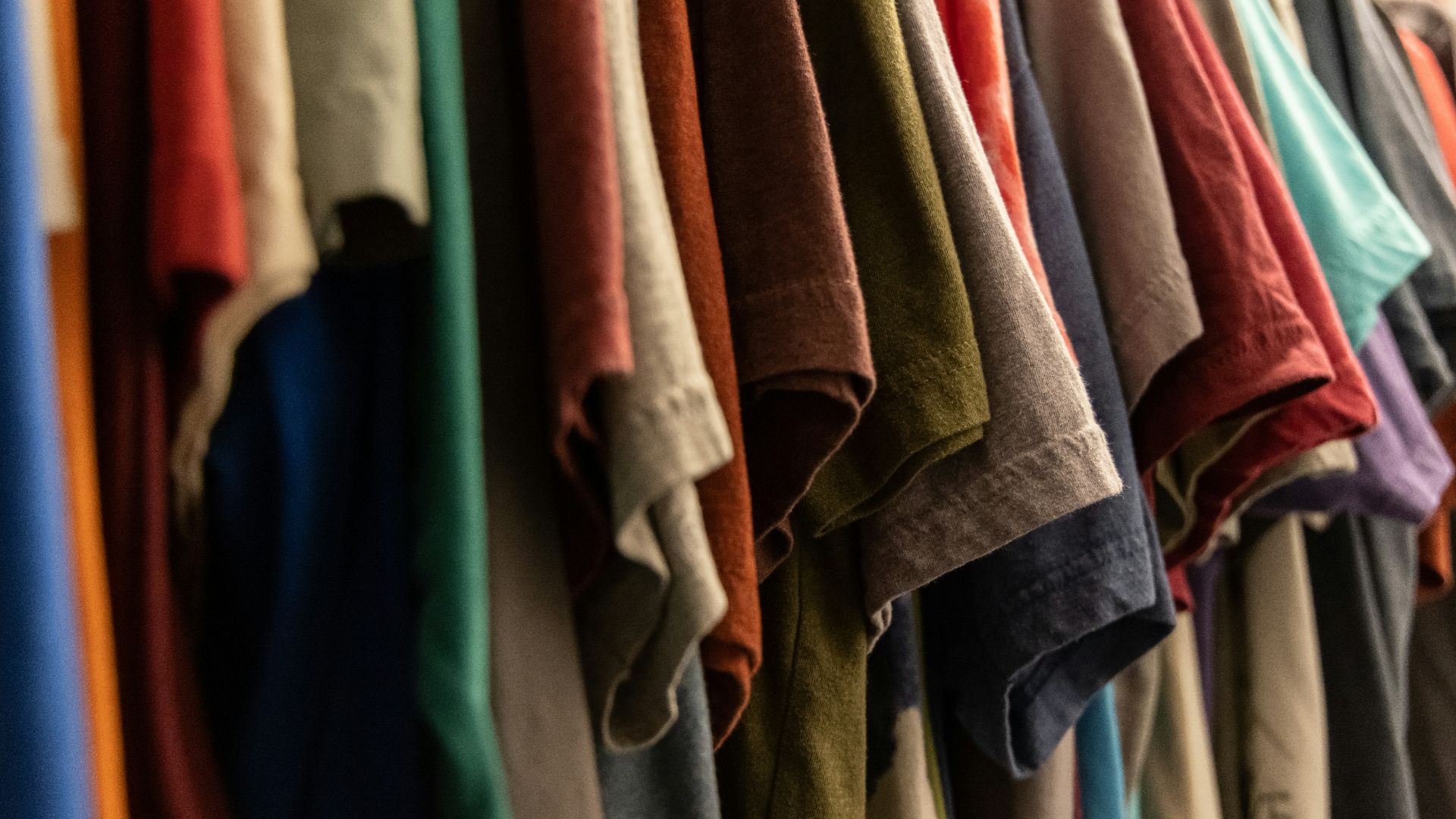 assorted clothes hanged on rack