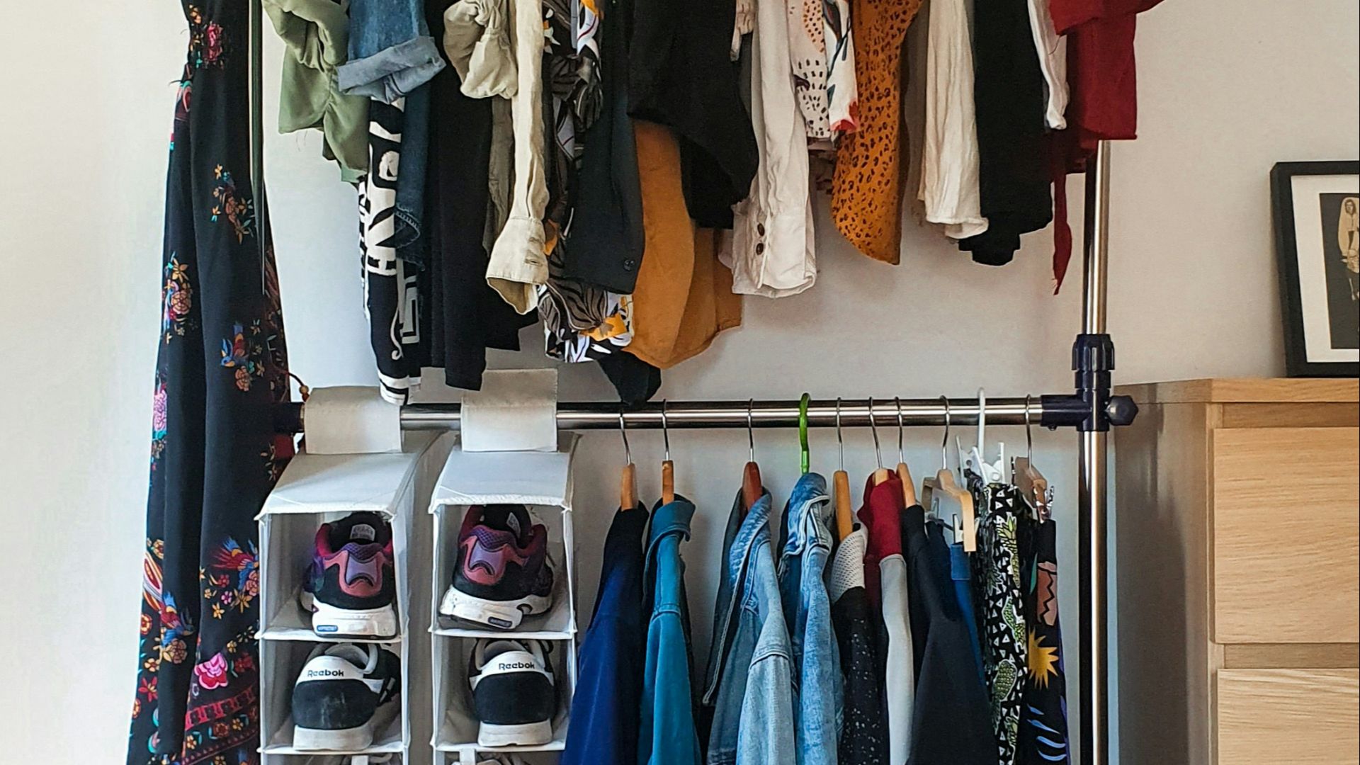 clothes hanged on brown wooden cabinet