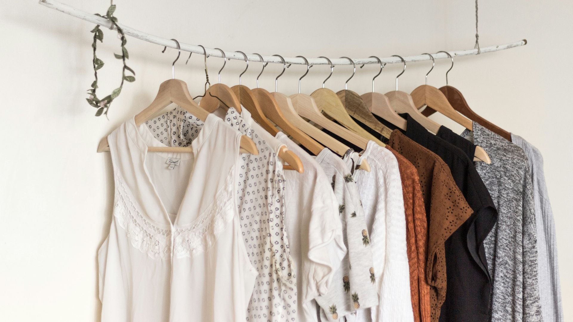 assorted clothes in wooden hangers