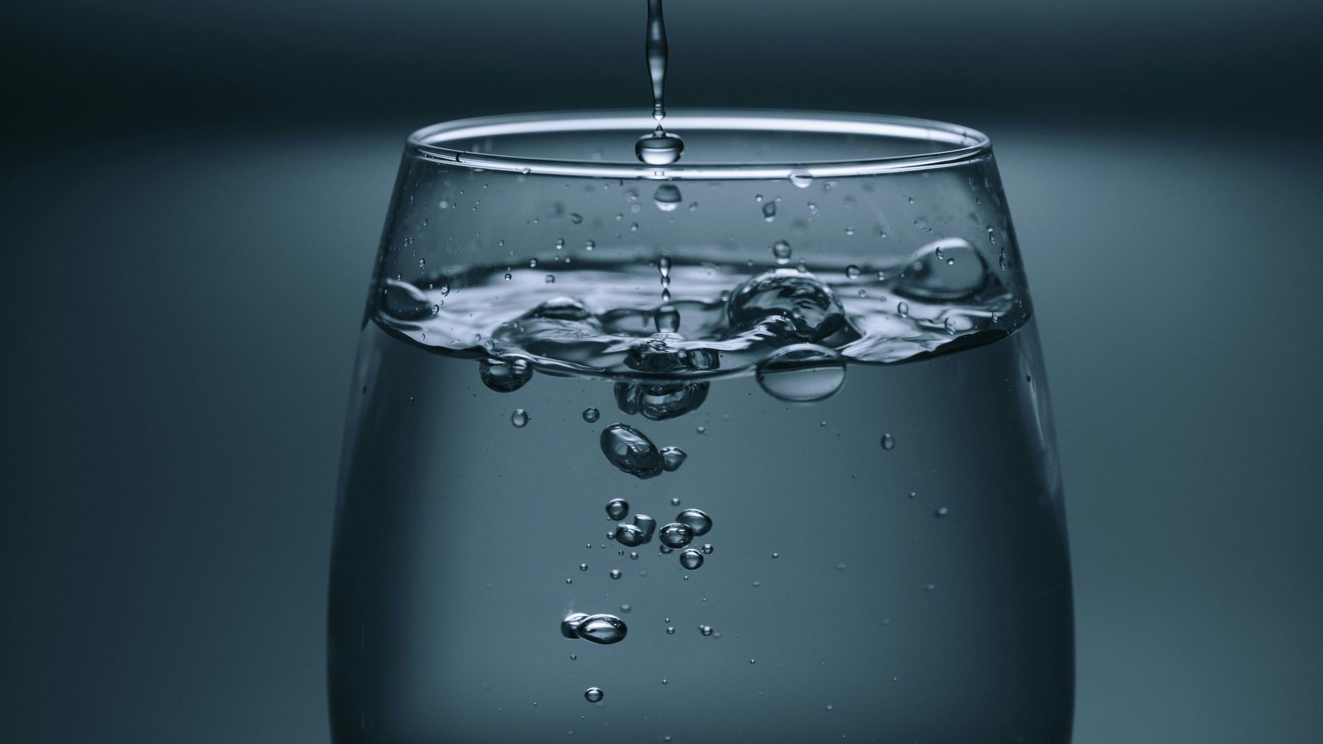 clear drinking glass on gray surface