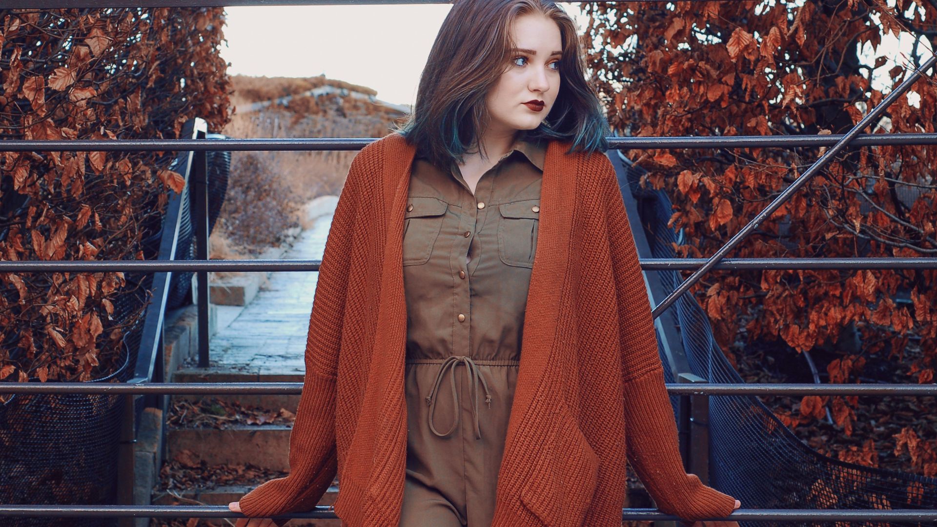 woman wearing brown button-up dress and orange open long-sleeved cardigan during daytime