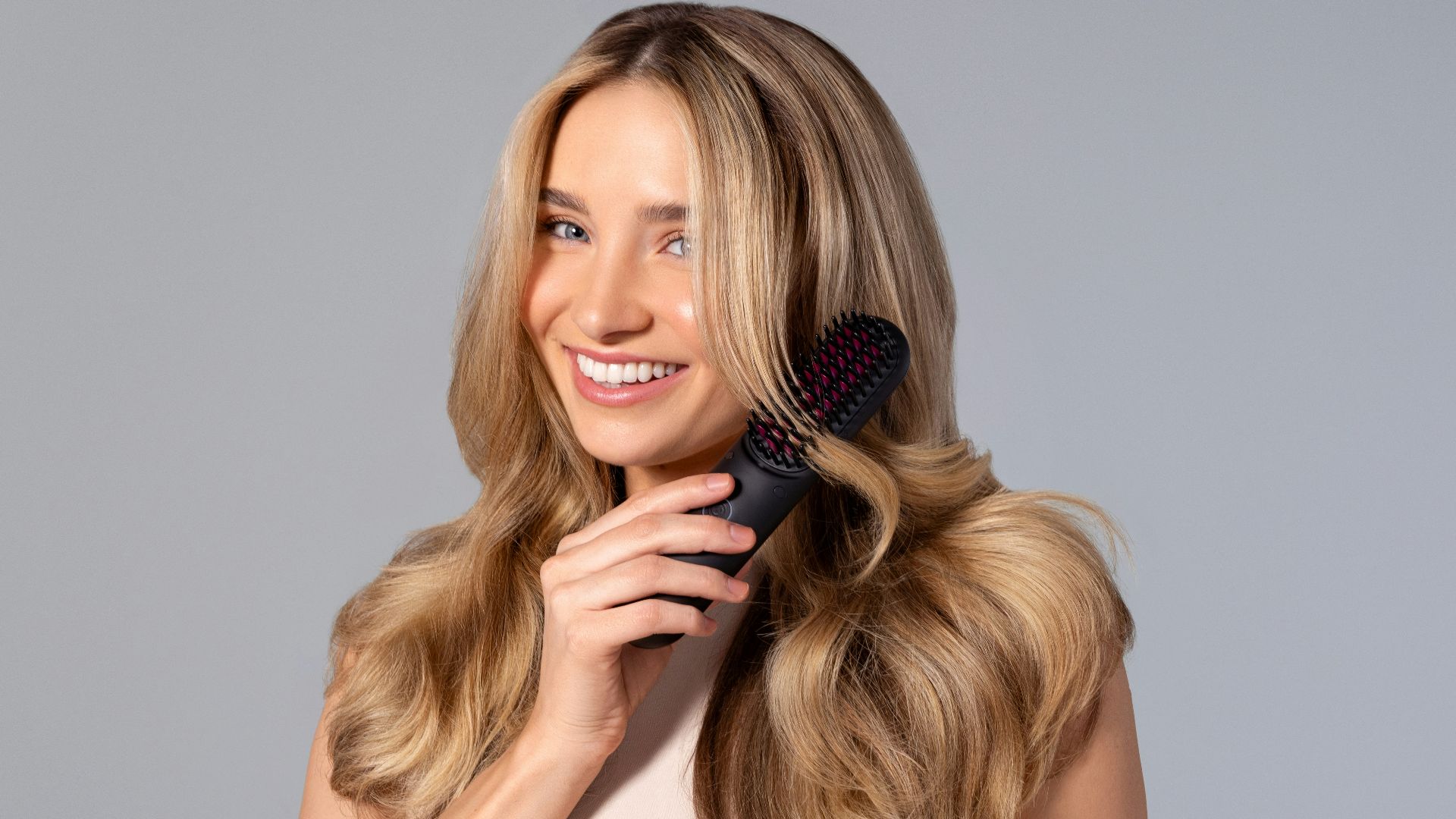 a woman holding a hair brush in her hand