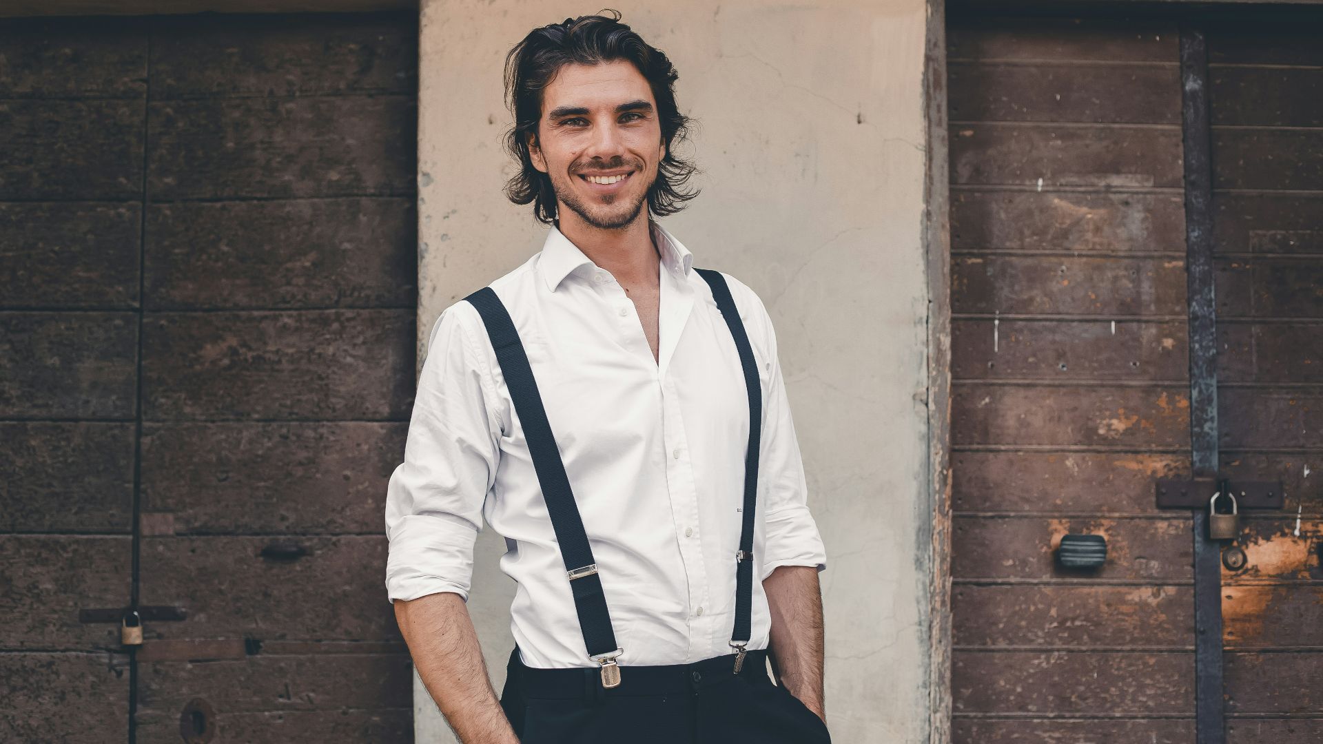 a person wearing a white shirt and suspenders