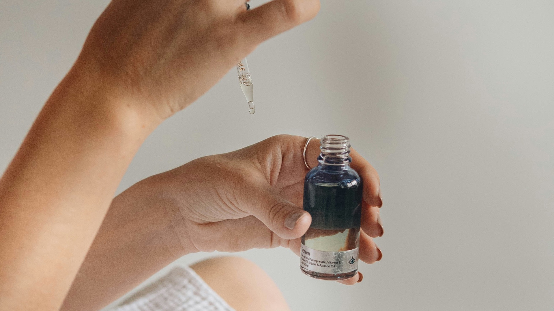 person holding black glass bottle