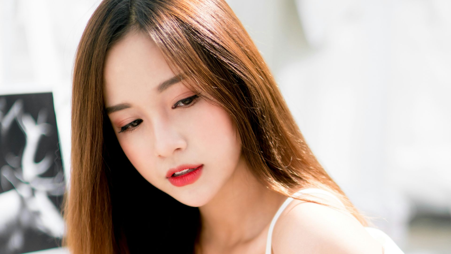 woman sitting on white metal stair railing during daytime