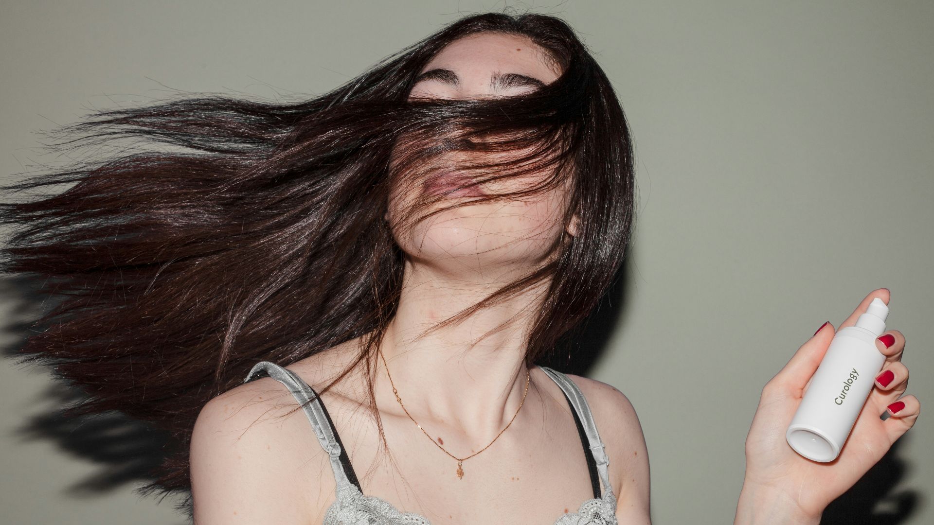 woman holding spray bottle