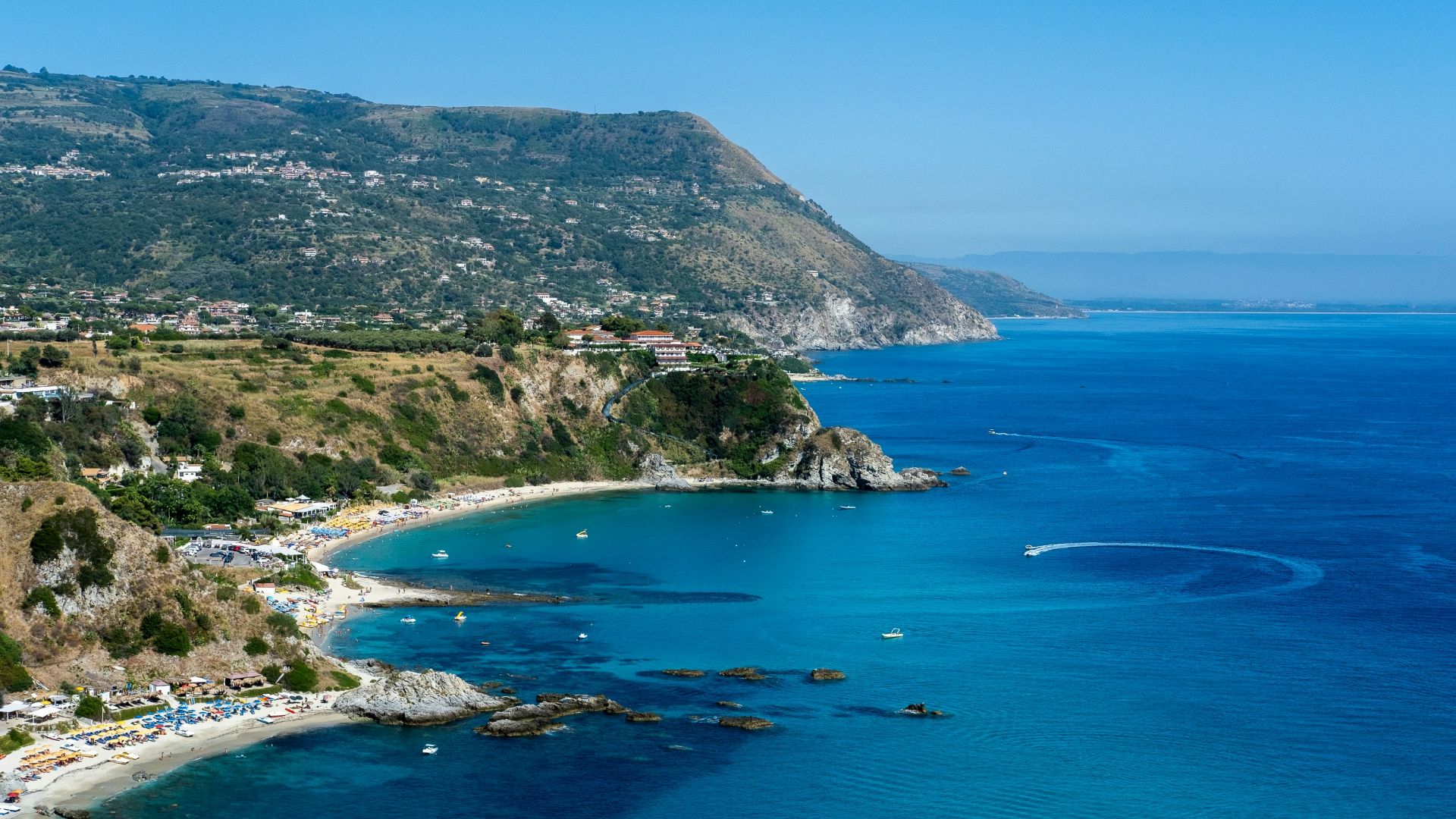 a view of a beach with a boat in the water
