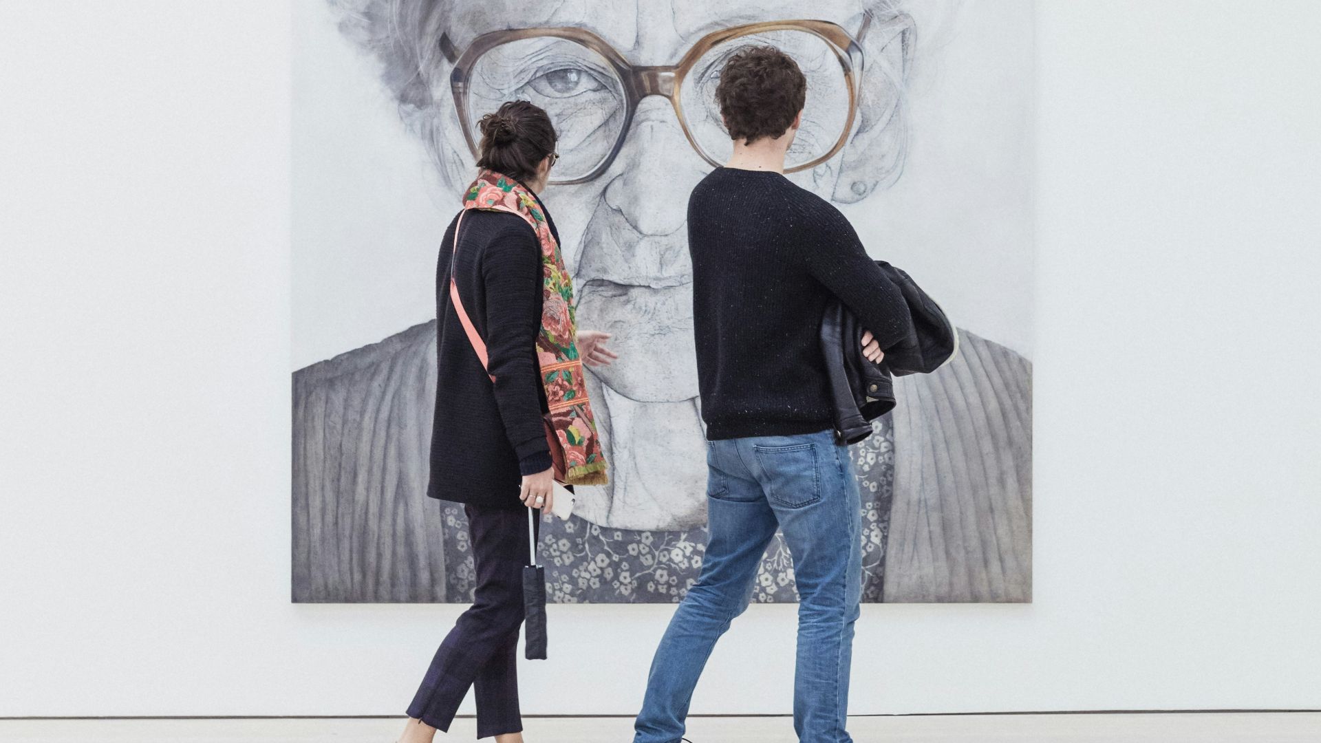man and woman looking at woman's painting