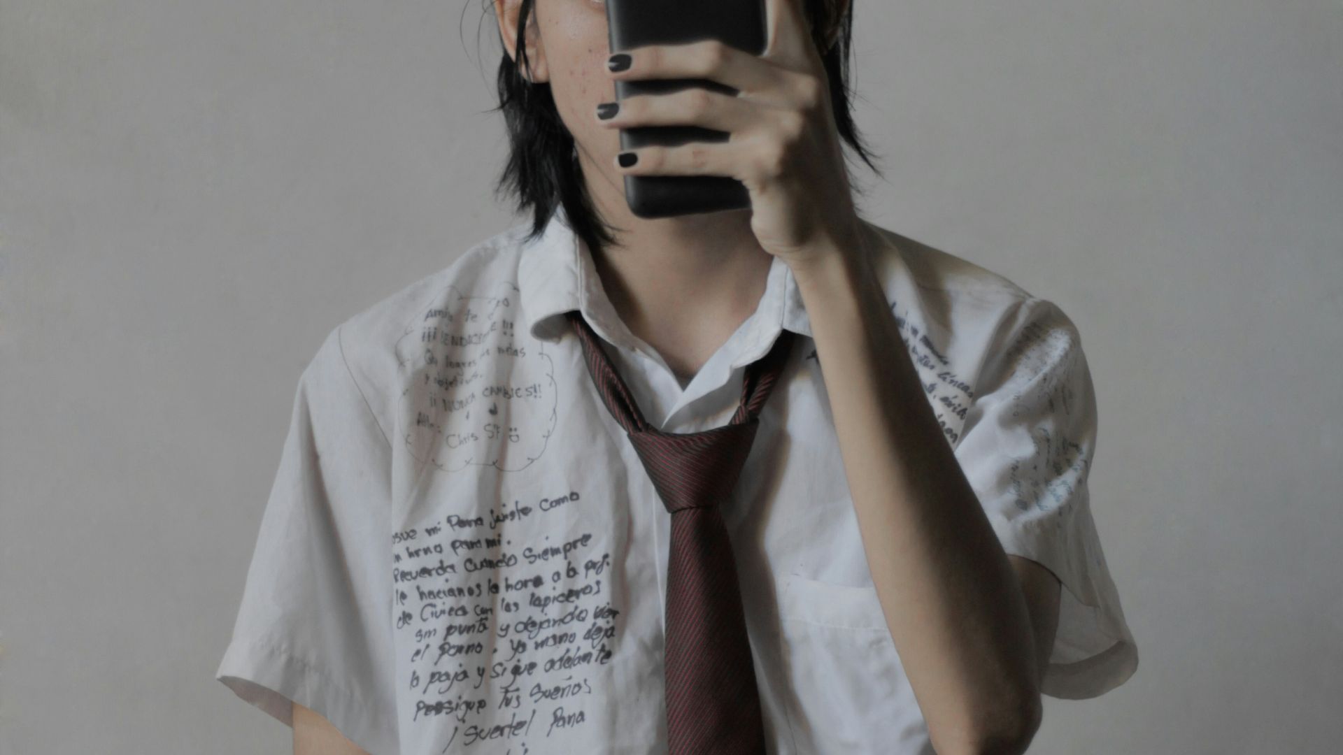 a man taking a picture of himself with a cell phone