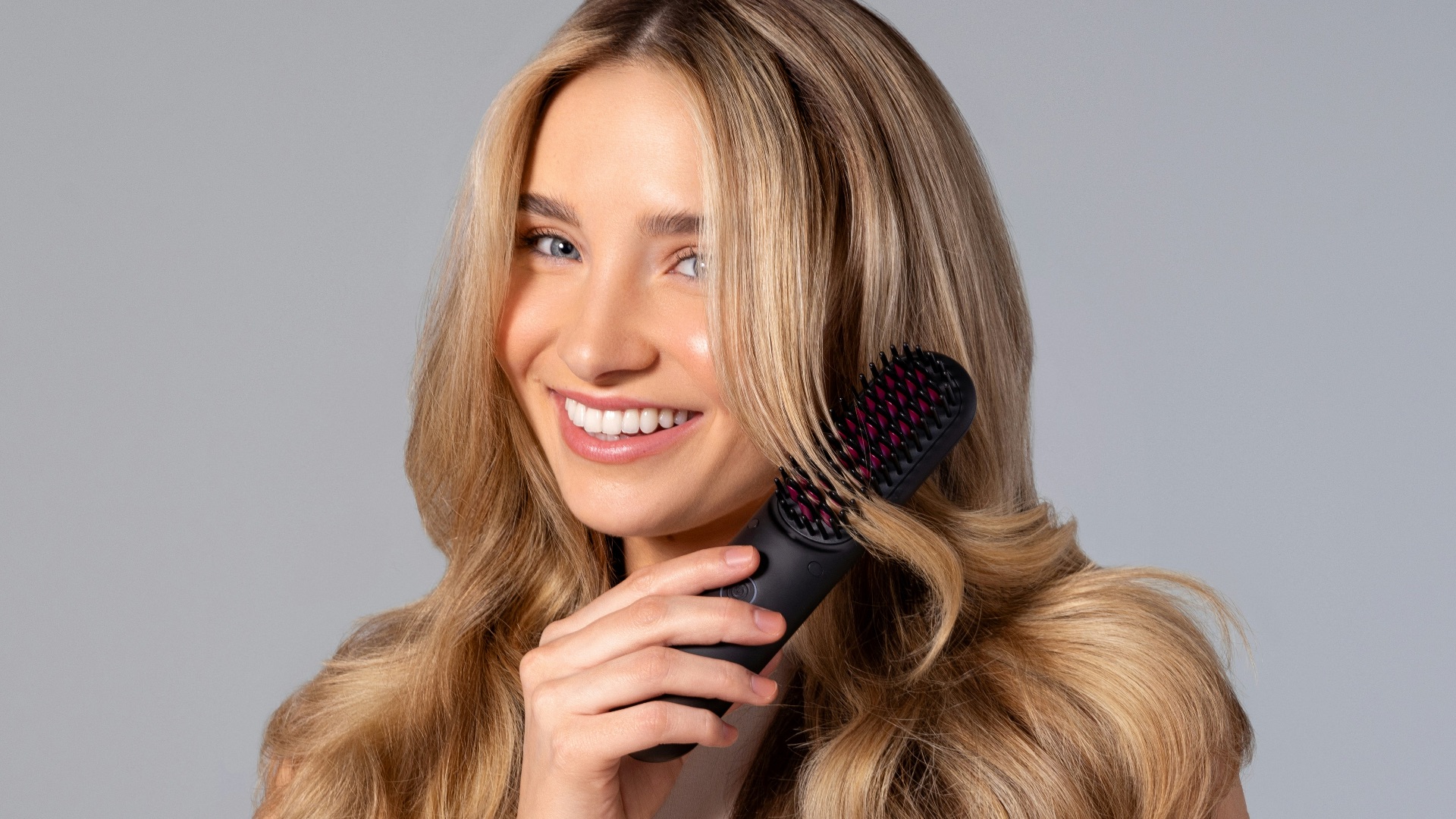 a woman holding a hair brush in her hand