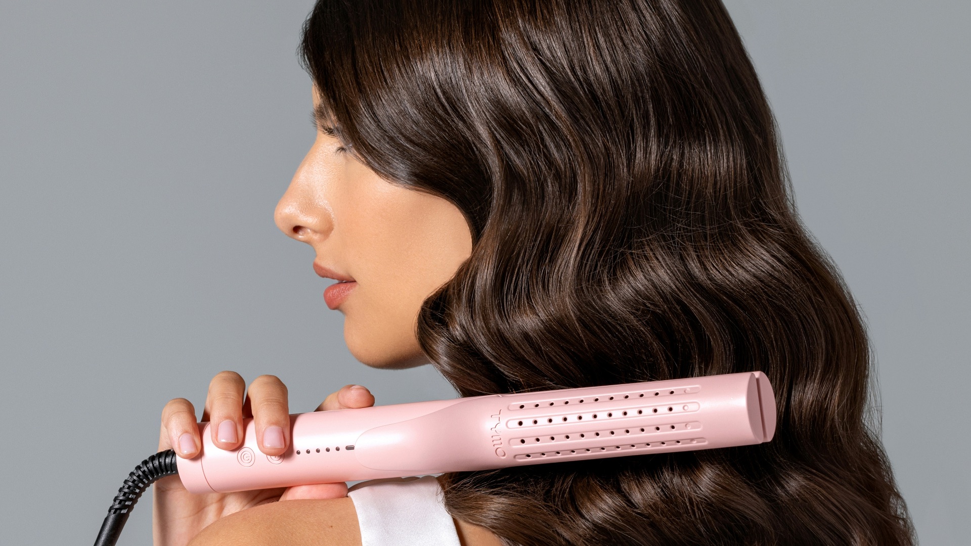 a woman using a hair dryer on her back