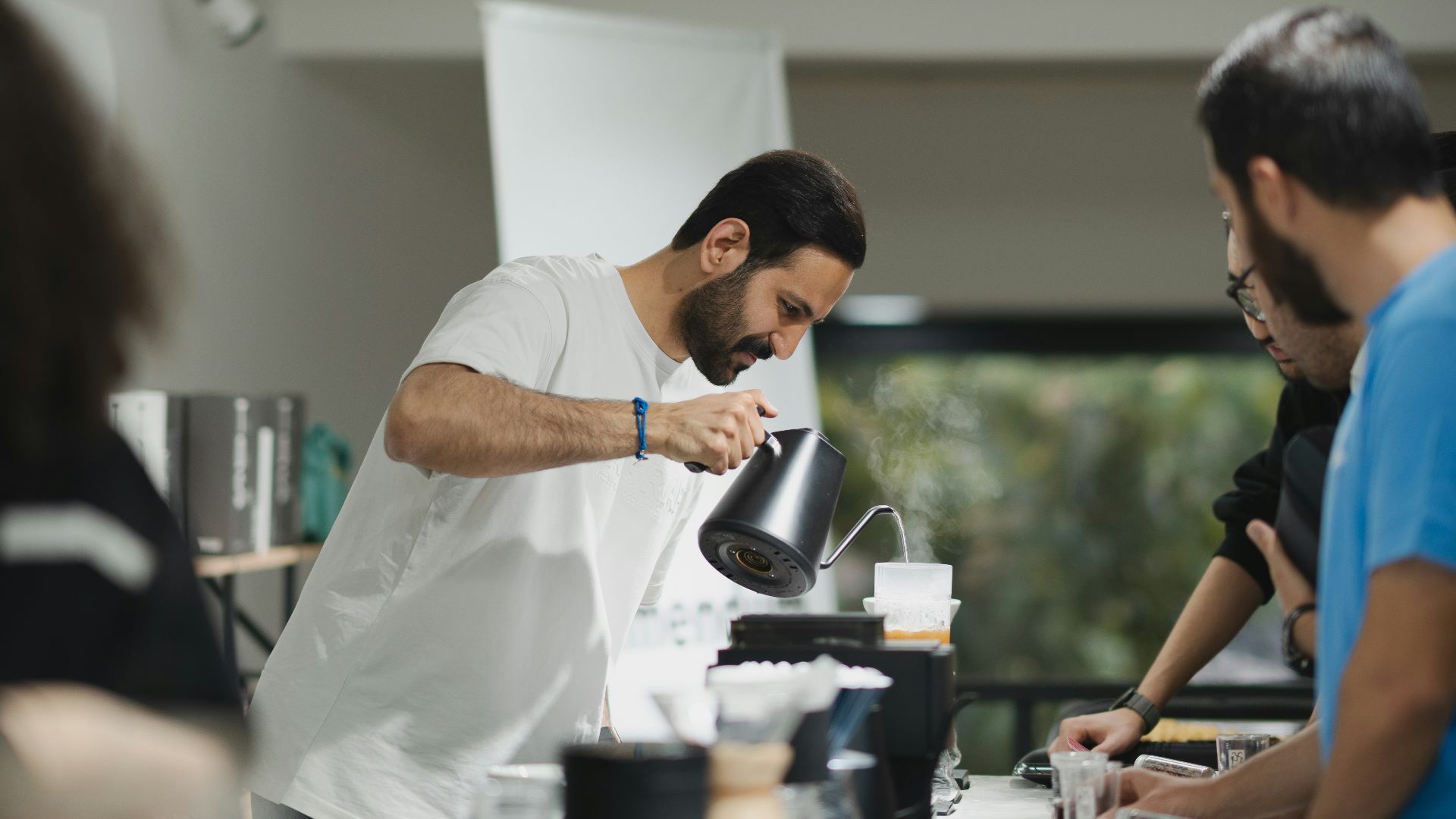 a group of people standing around a table