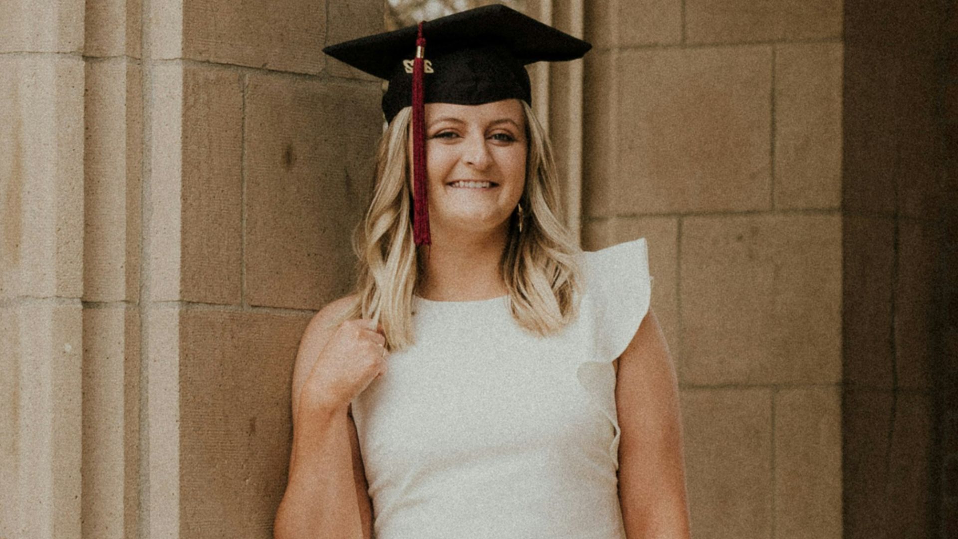 a person wearing a graduation gown