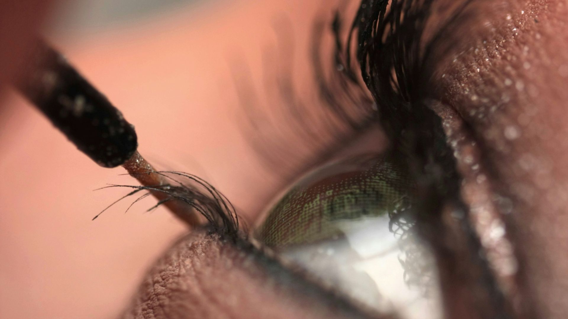 persons eye with black hair tie