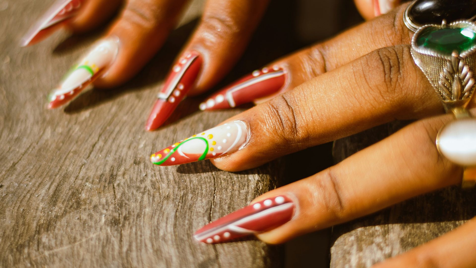 A close up of a person's hands with rings on them