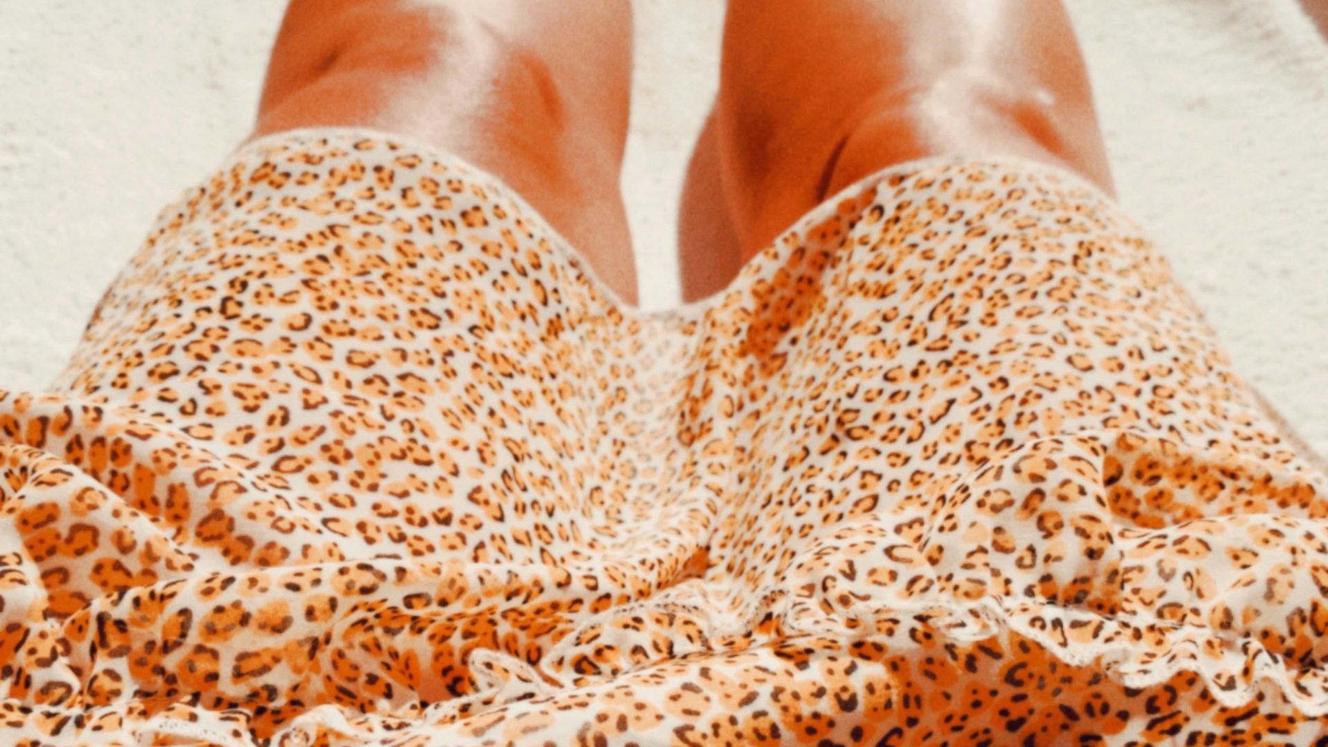 person in brown and white leopard print pants