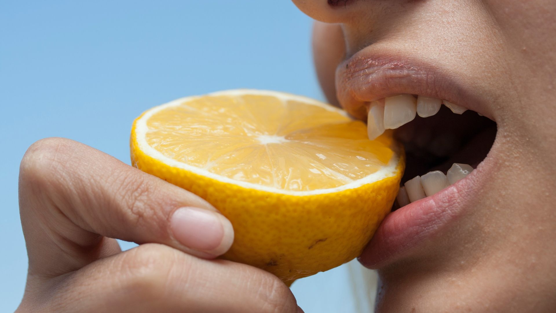 person holding orange fruit during daytime
