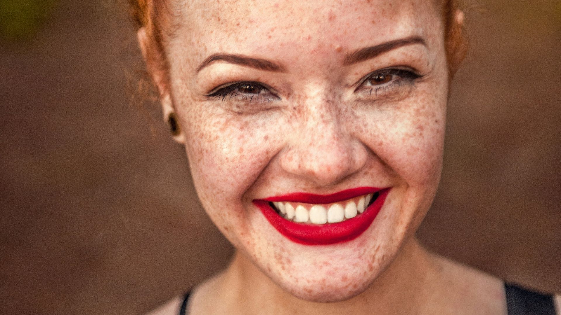 woman taking photo while showing smile