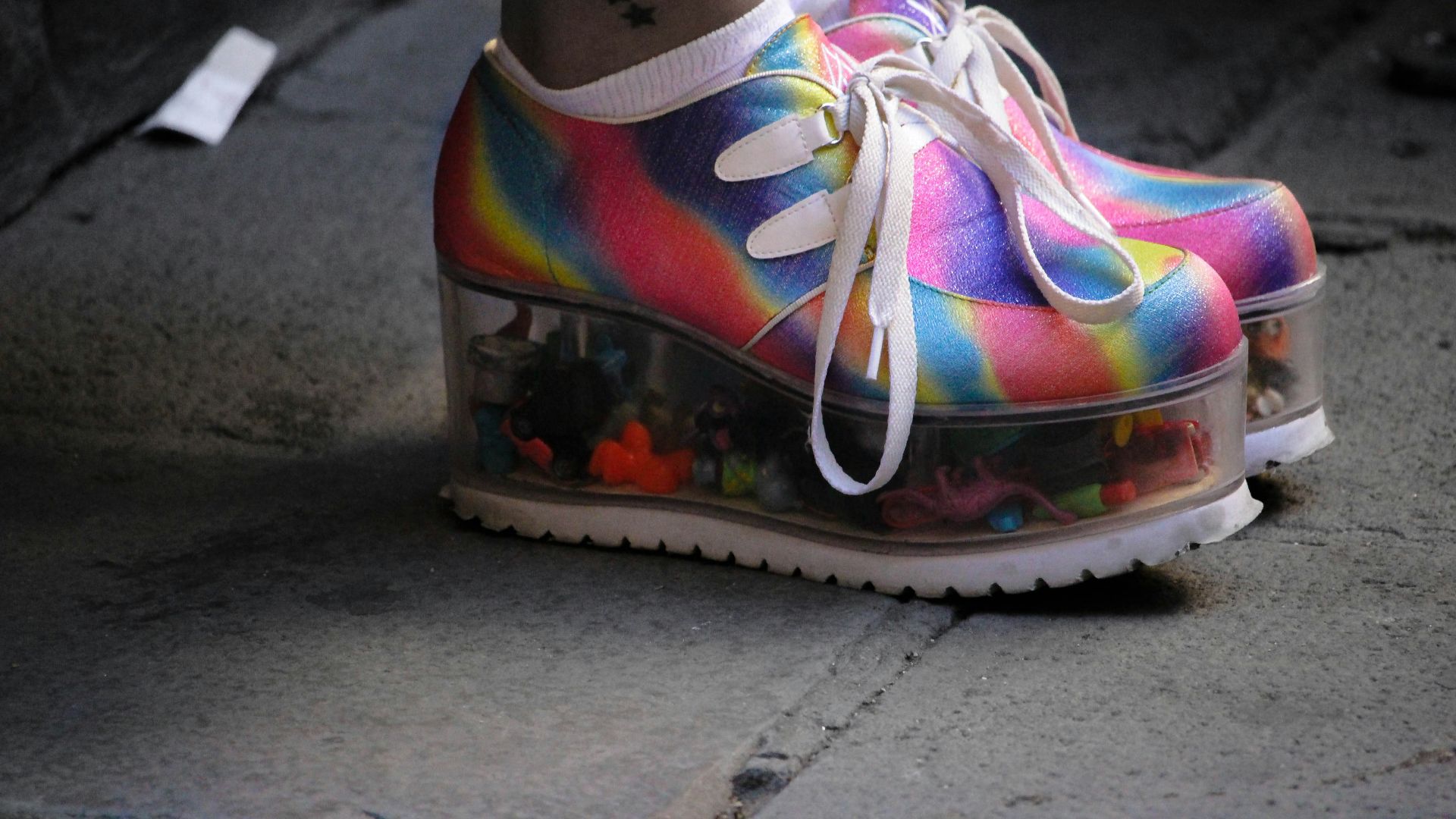 person wearing multicolored wedge shoes