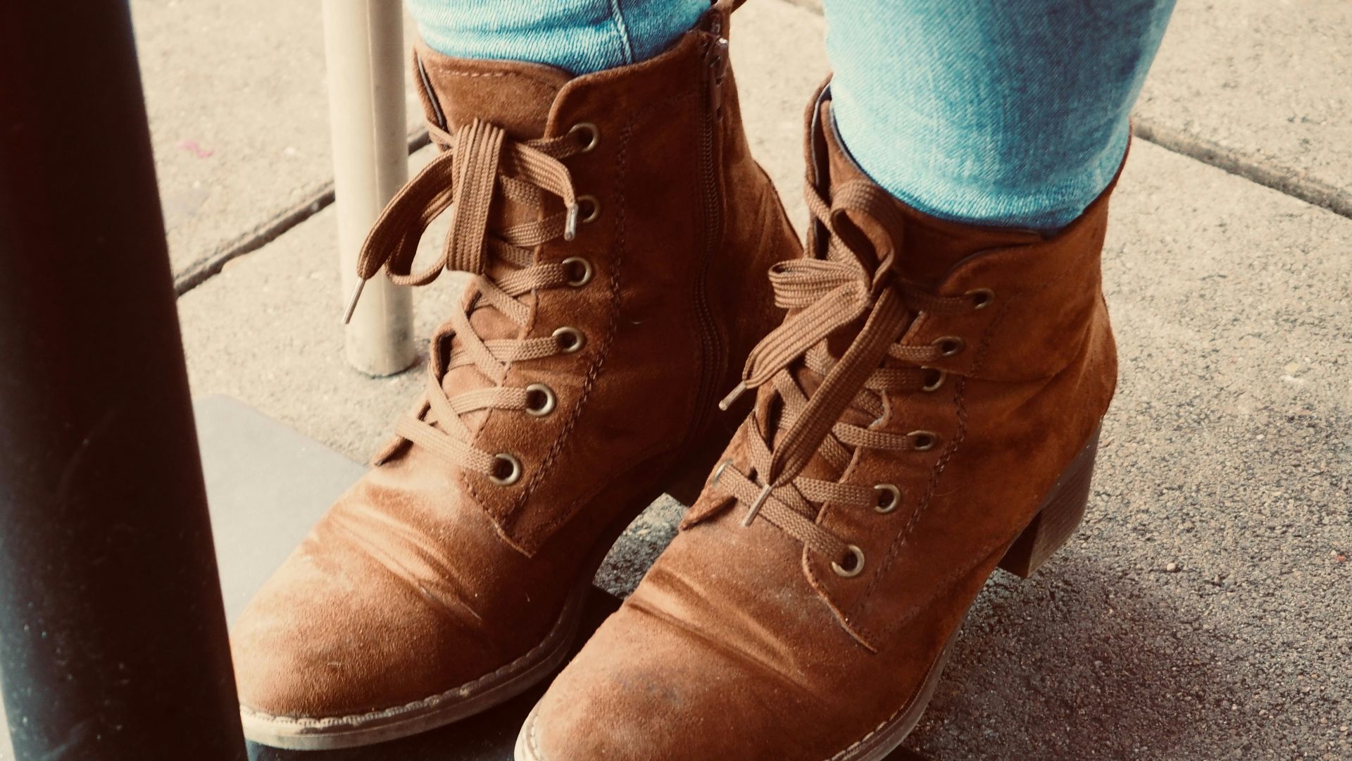 Brown suede lace-up ankle boots with jeans