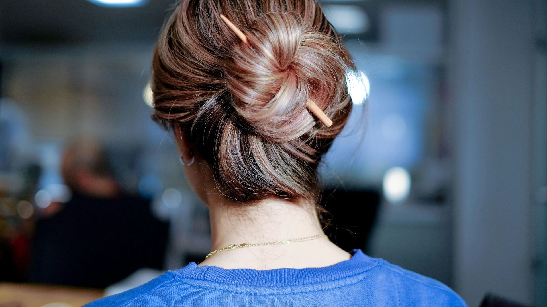 woman wearing blue top inside room
