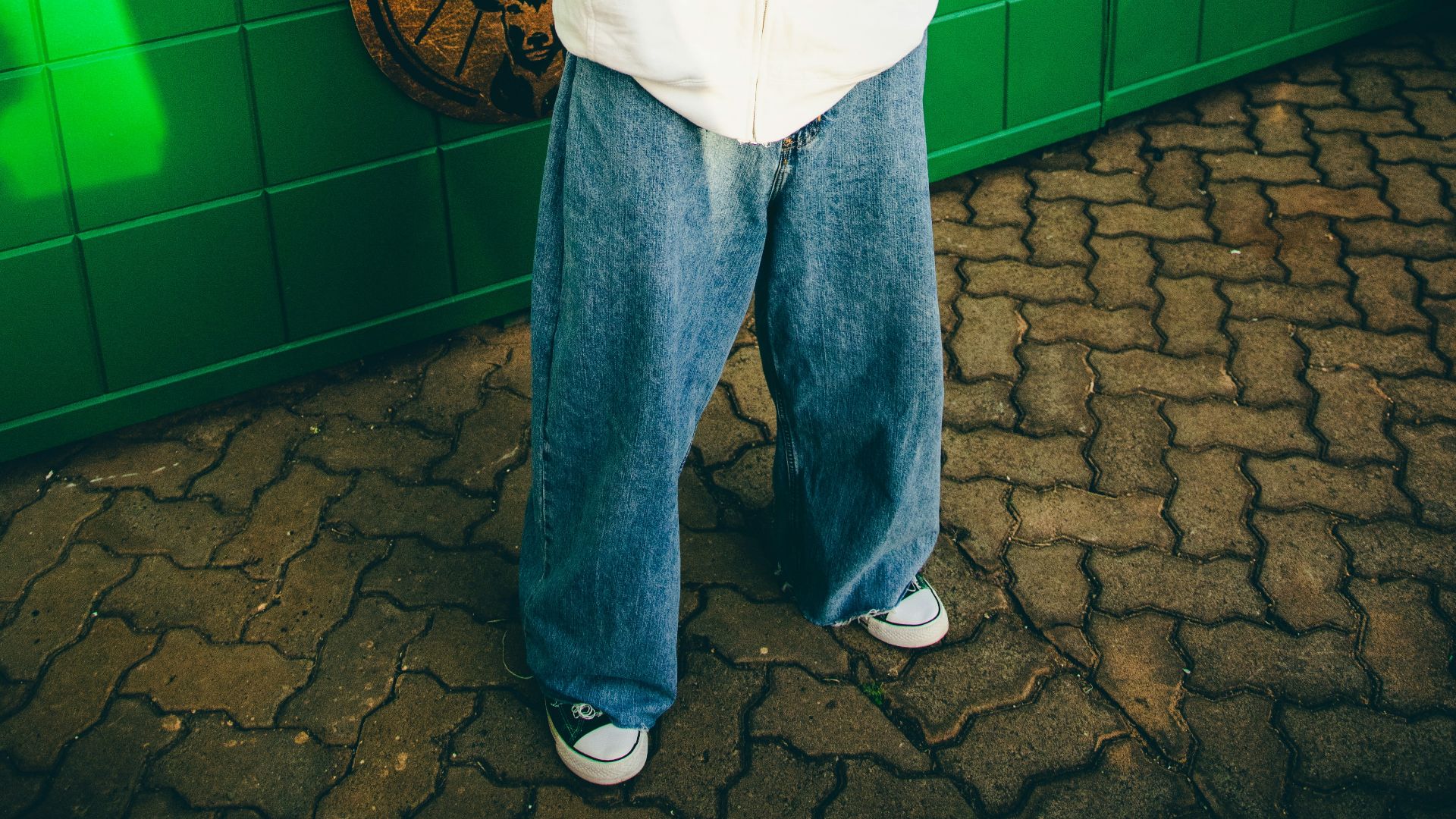 A man is standing in front of a store