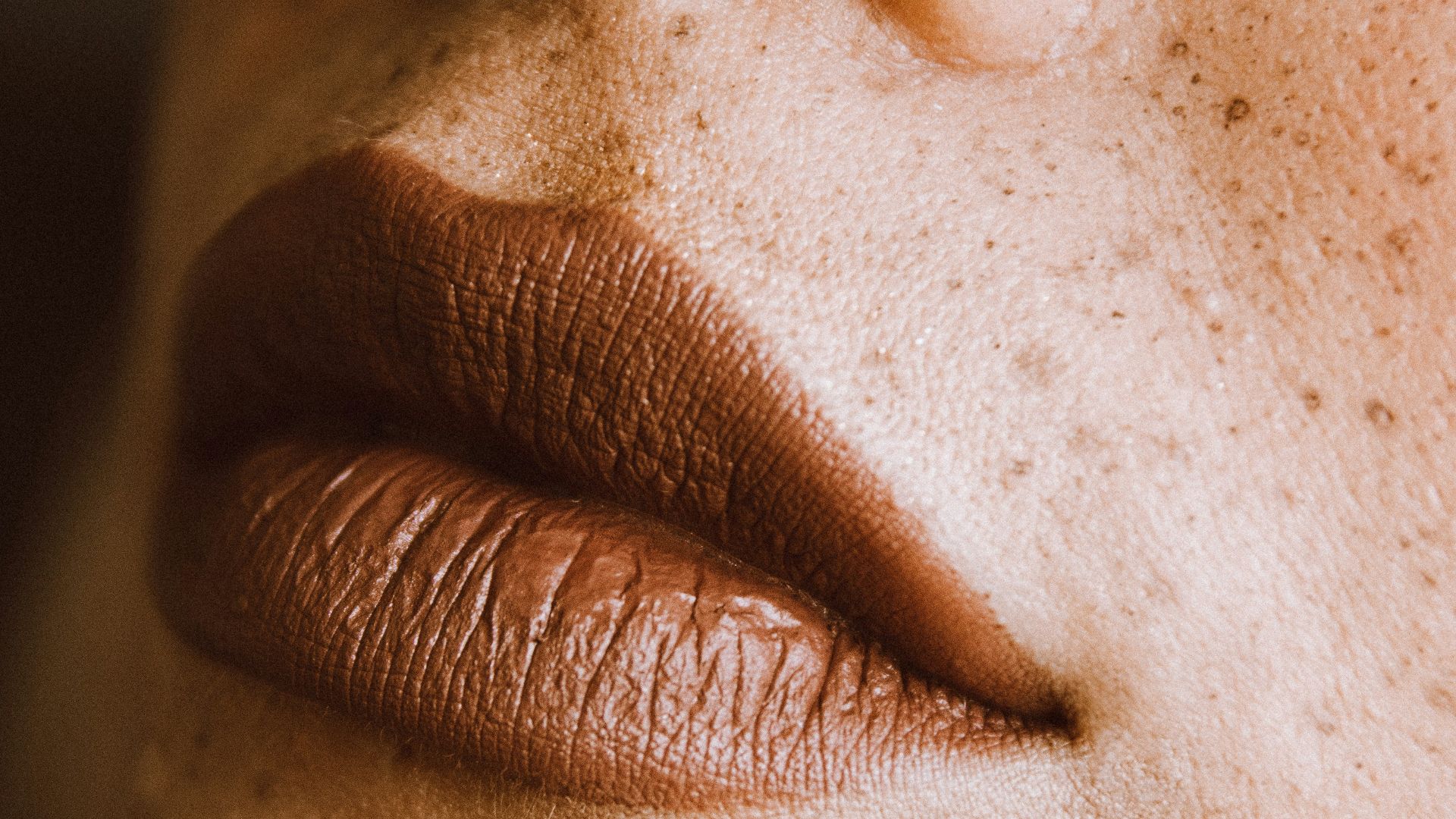 a close up of a woman's face with freckles
