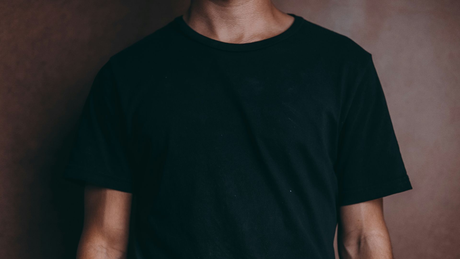 man wearing black crew-neck t-shirt