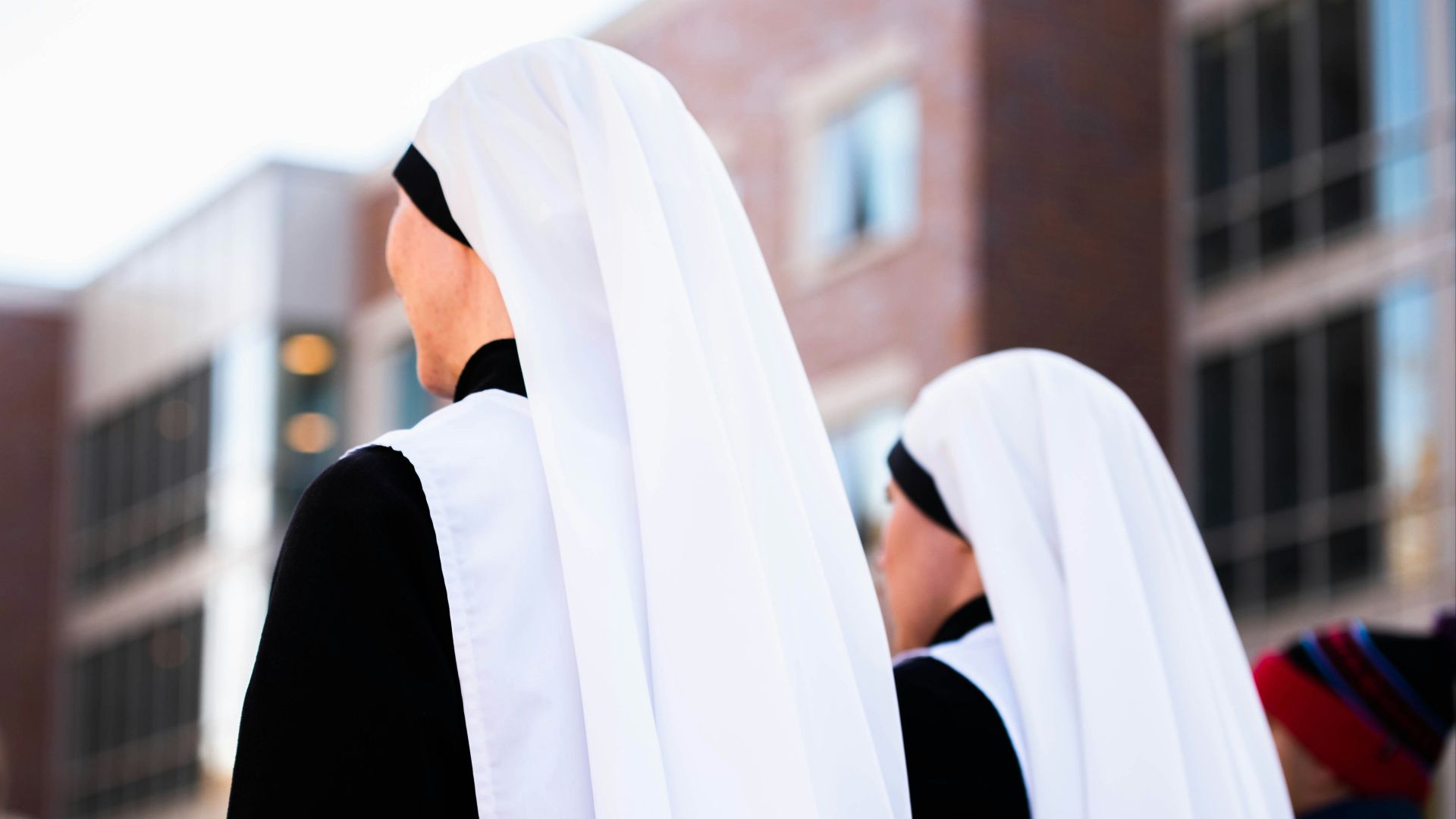 a group of women dressed in black and white