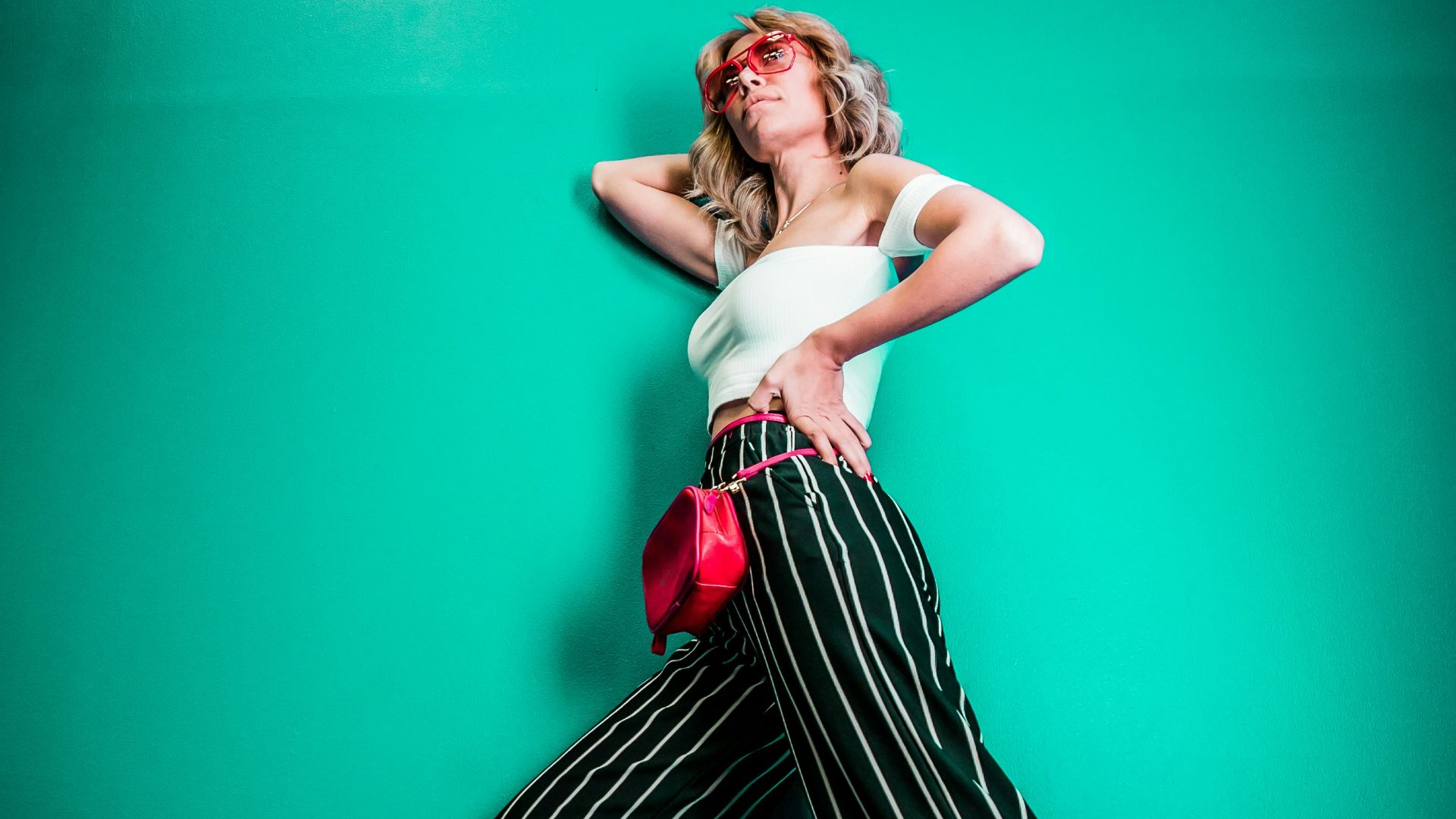 posing woman in white sleeveless top