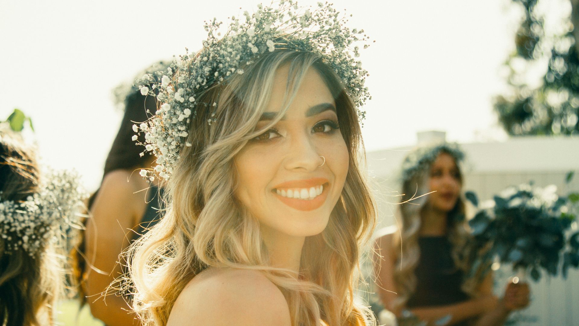 woman wearing headdress near two womens closeup photography