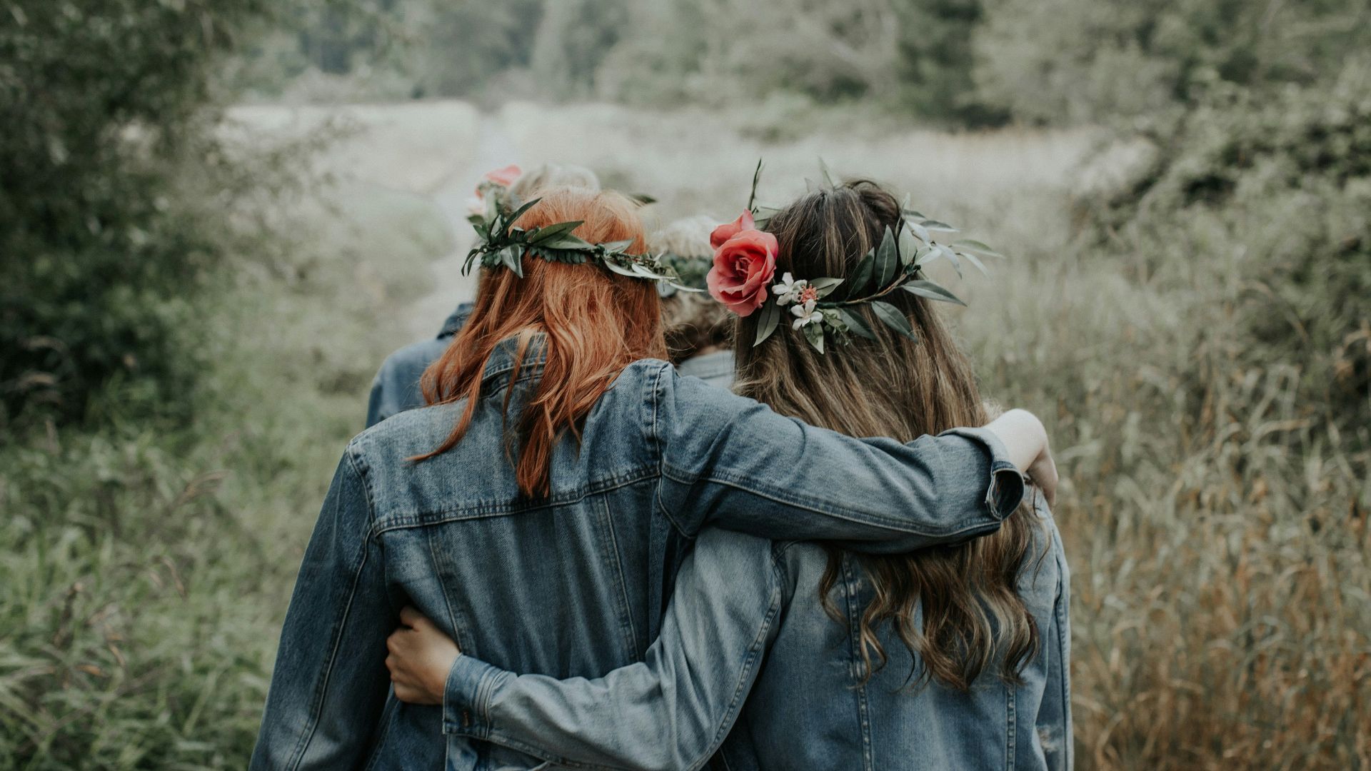 woman in blue denim jacket with red rose on ear