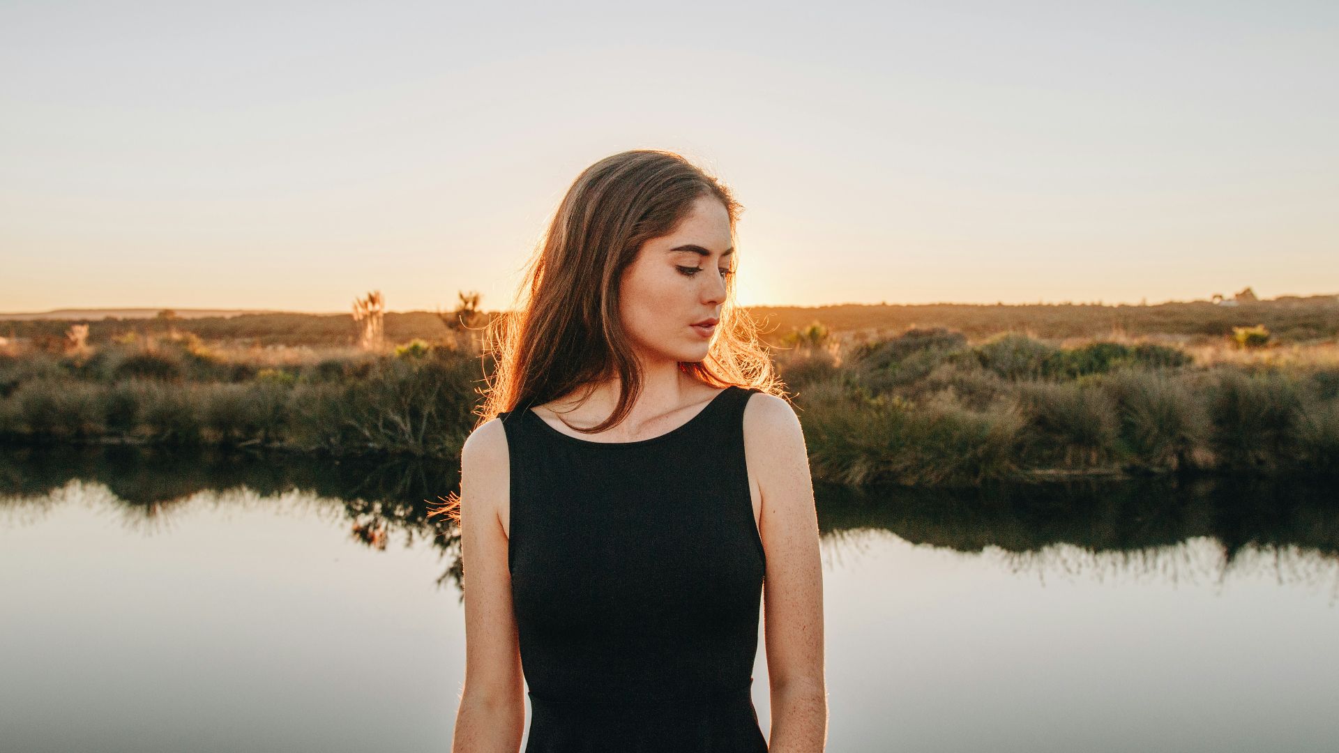 woman standing near pond