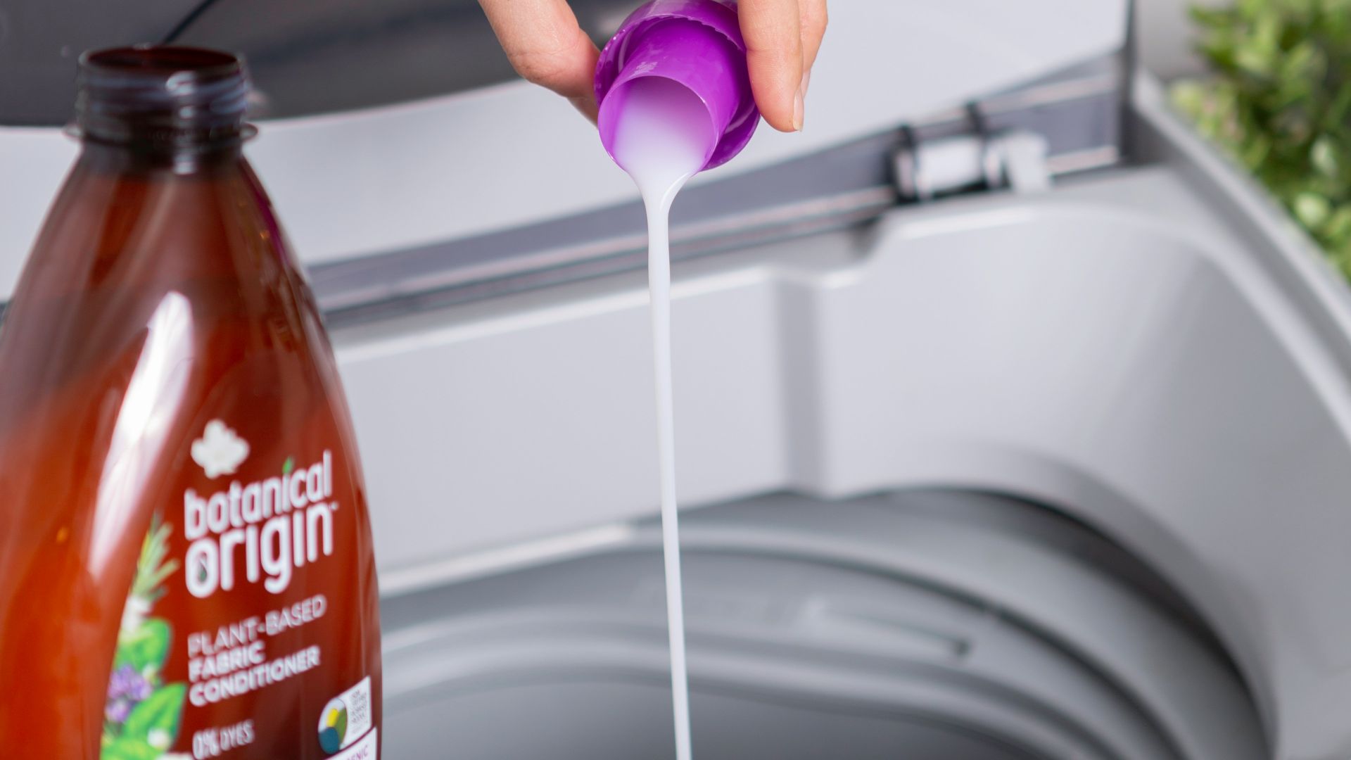 person holding purple plastic bottle