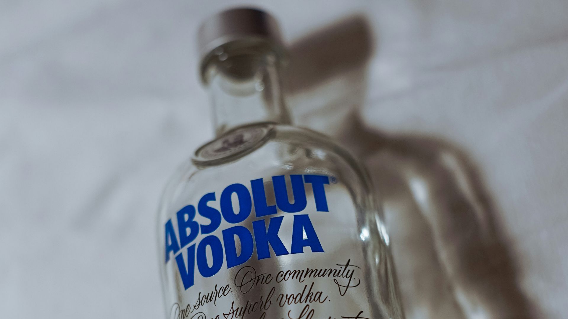 clear glass bottle on white textile