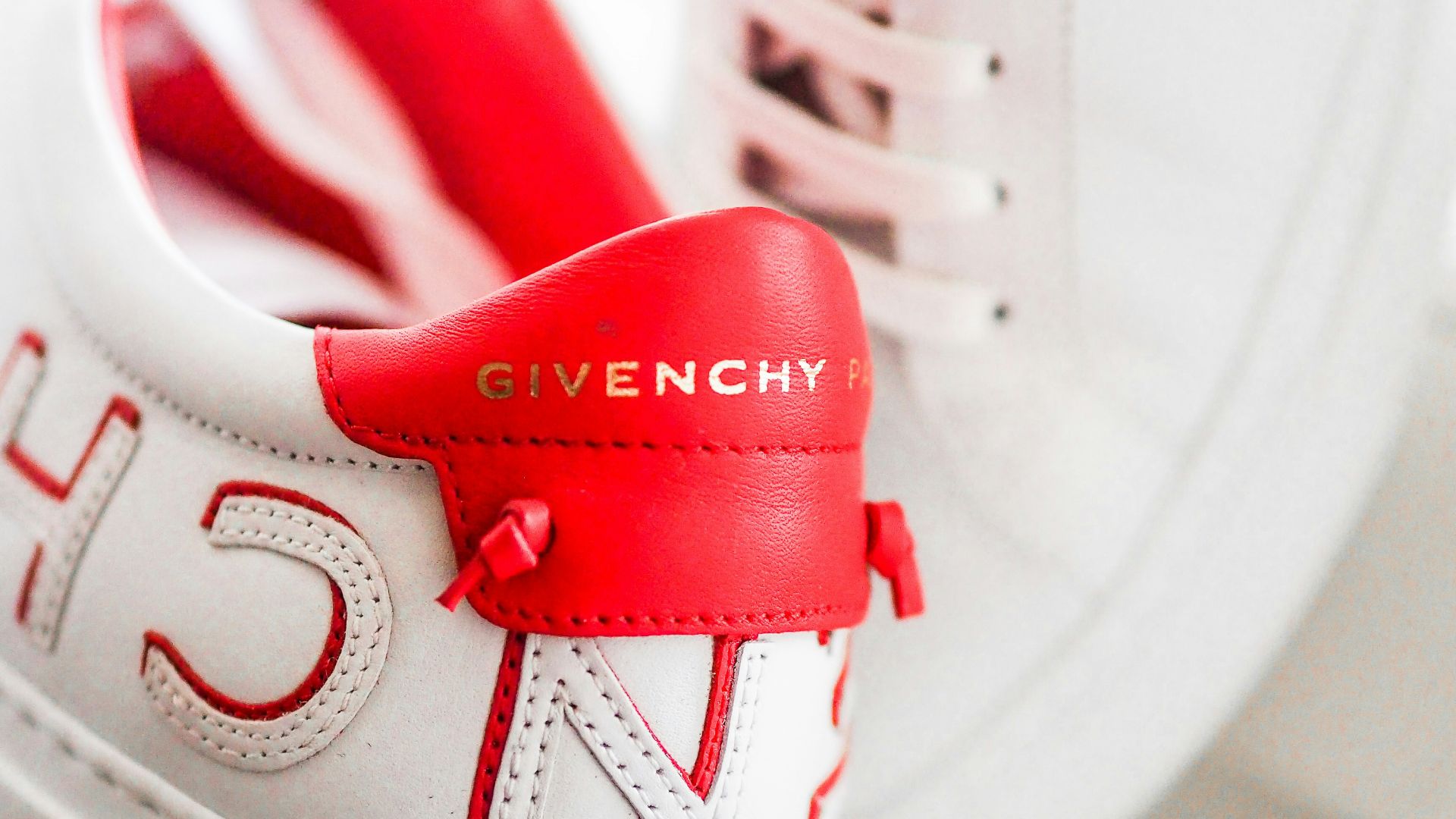 white and red nike athletic shoes