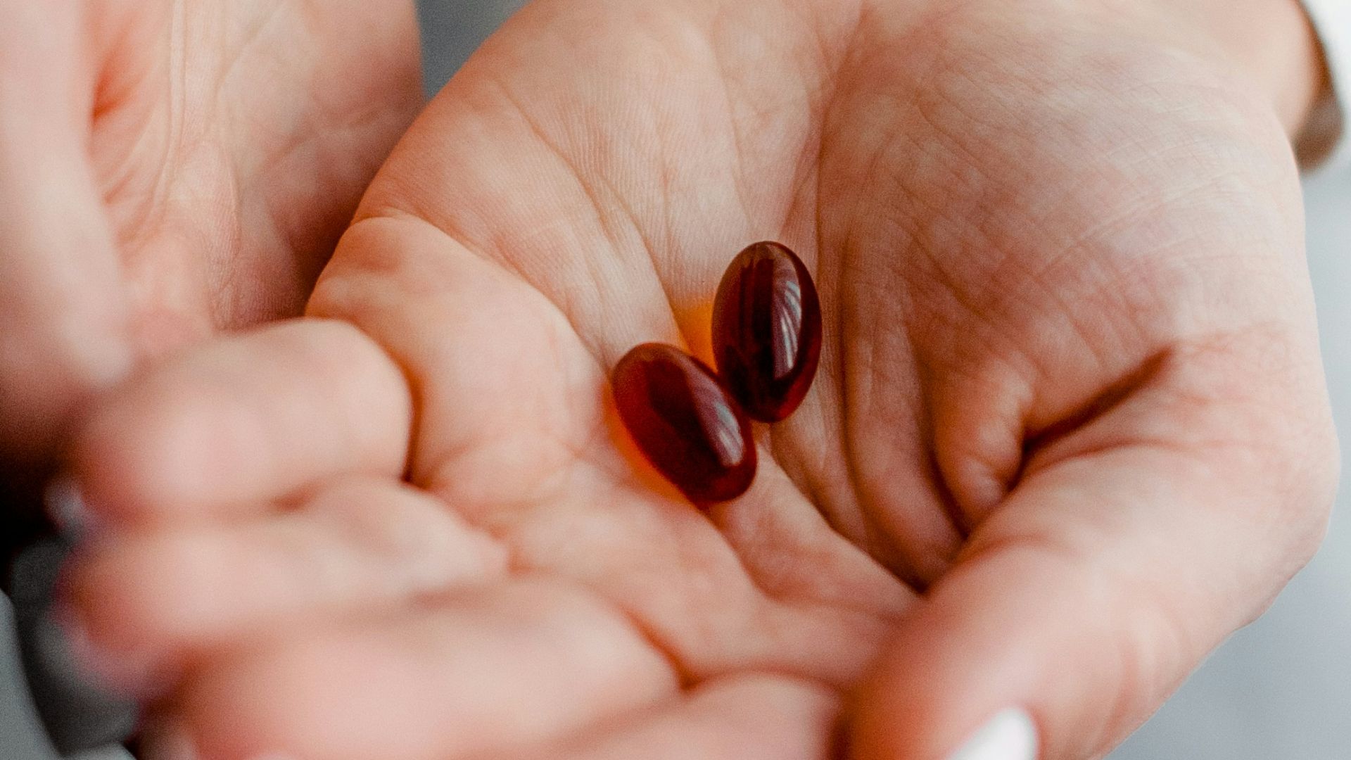 person holding brown and black round ornament