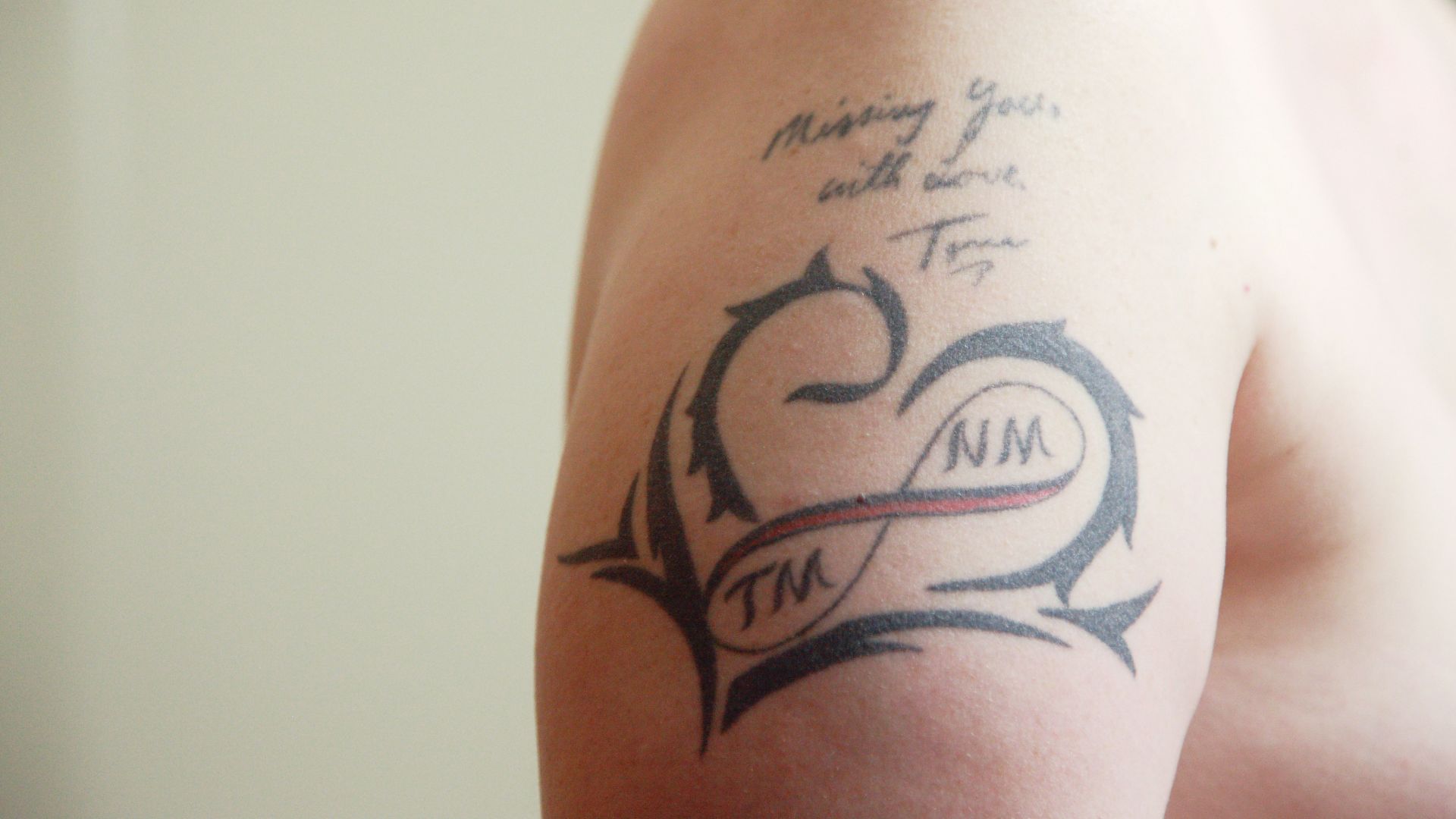 black and white tattoo on persons leg