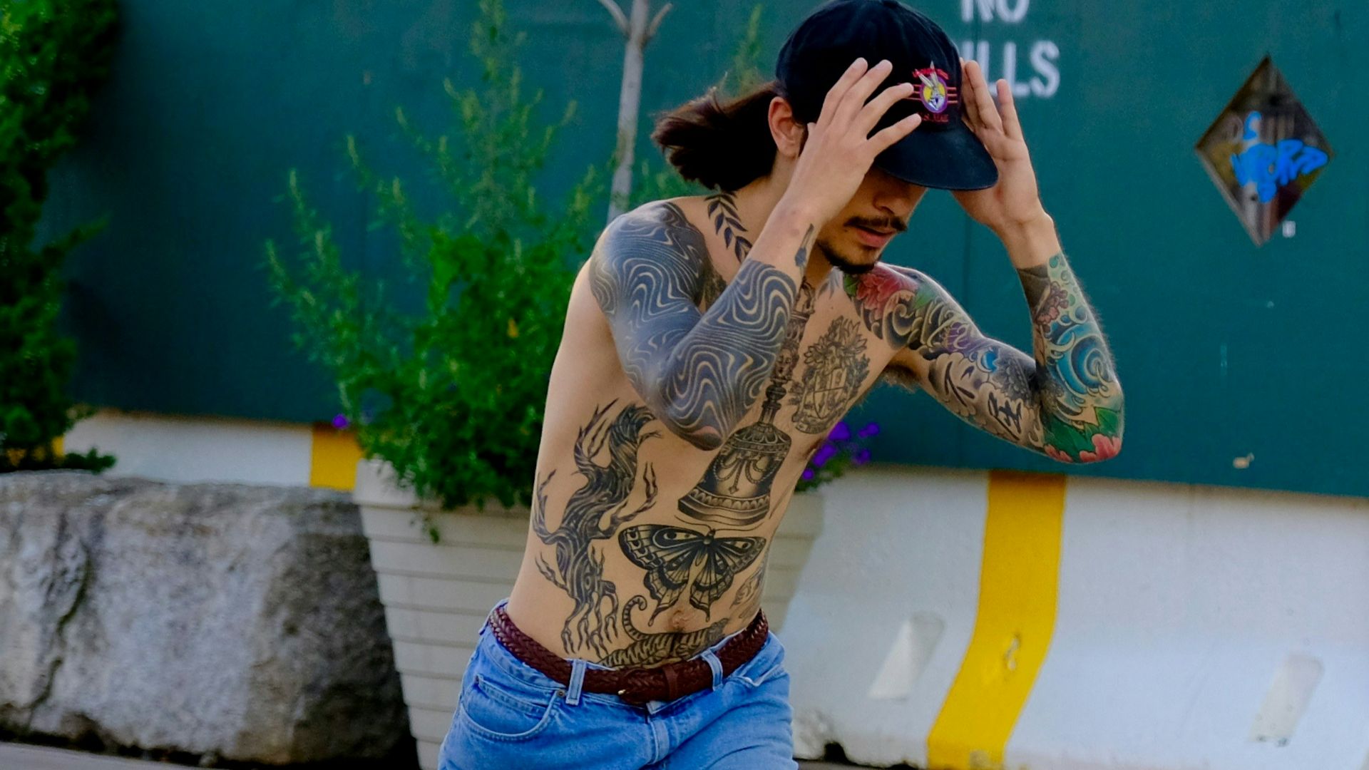 man wearing blue jeans riding on skateboard