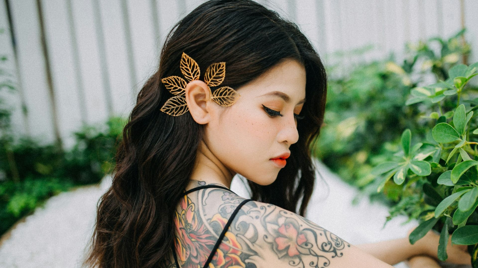 women's orange and black floral back tattoo